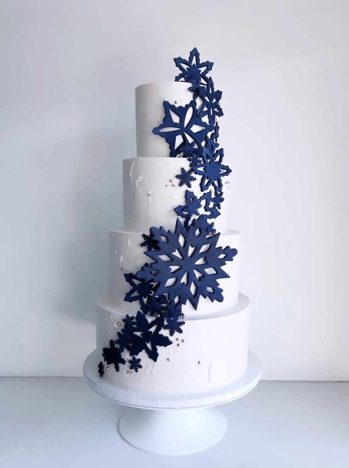 Soft textured buttercream with gold leaf details and fondant snowflakes