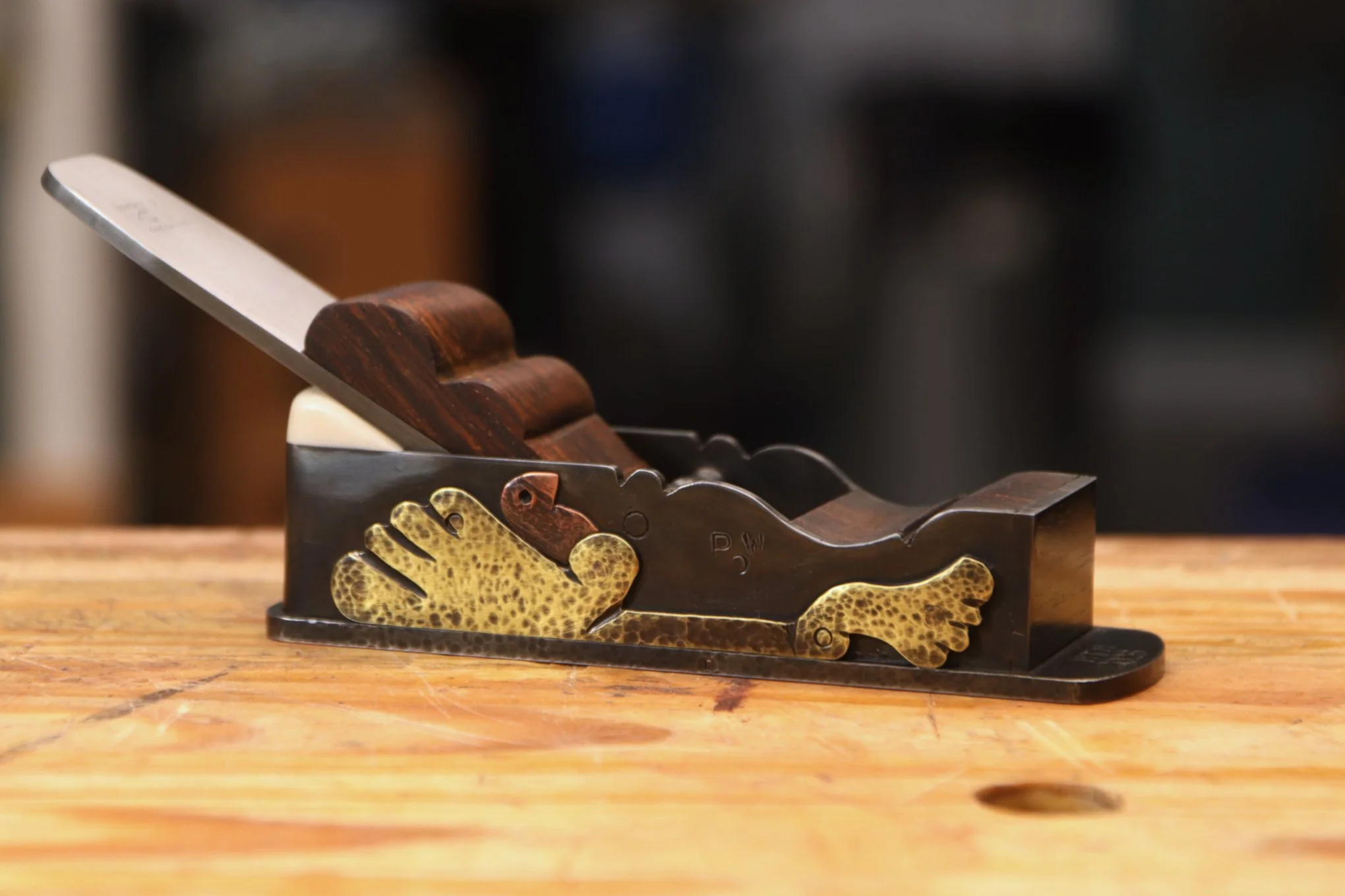 Steel miter plane with a turkey application made from brass and copper
