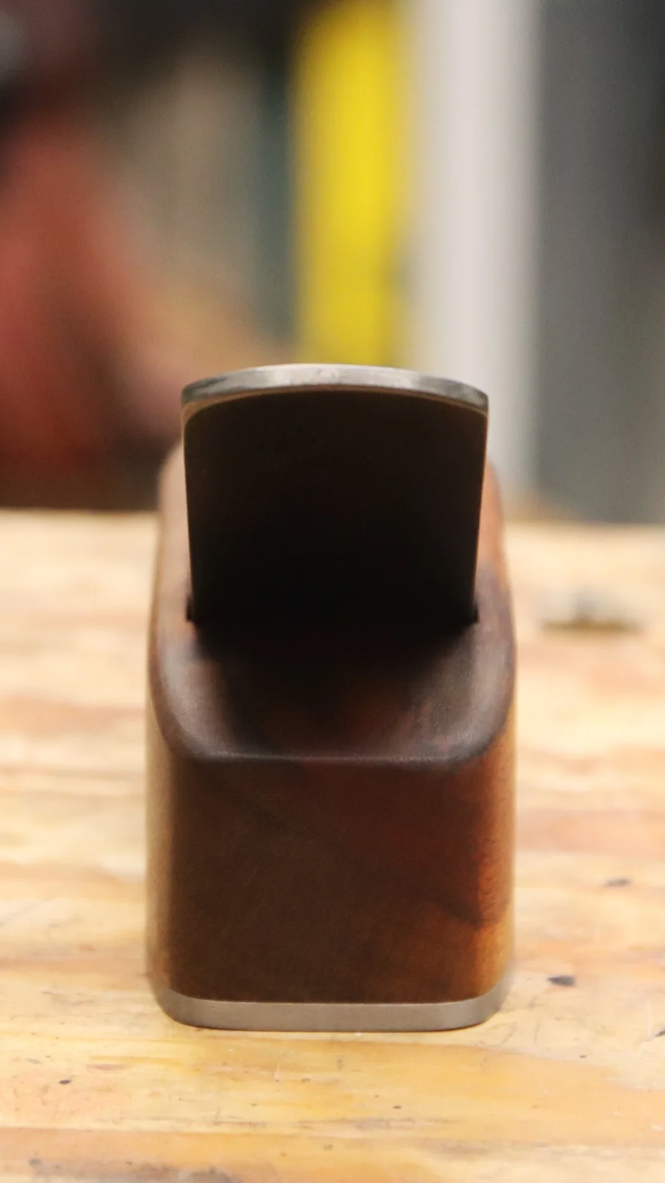 Block plane made from goncalo alves wood sitting on a work bench