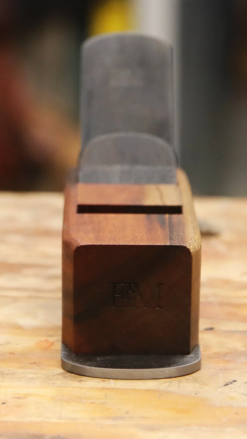 Block plane made from goncalo alves wood sitting on a work bench