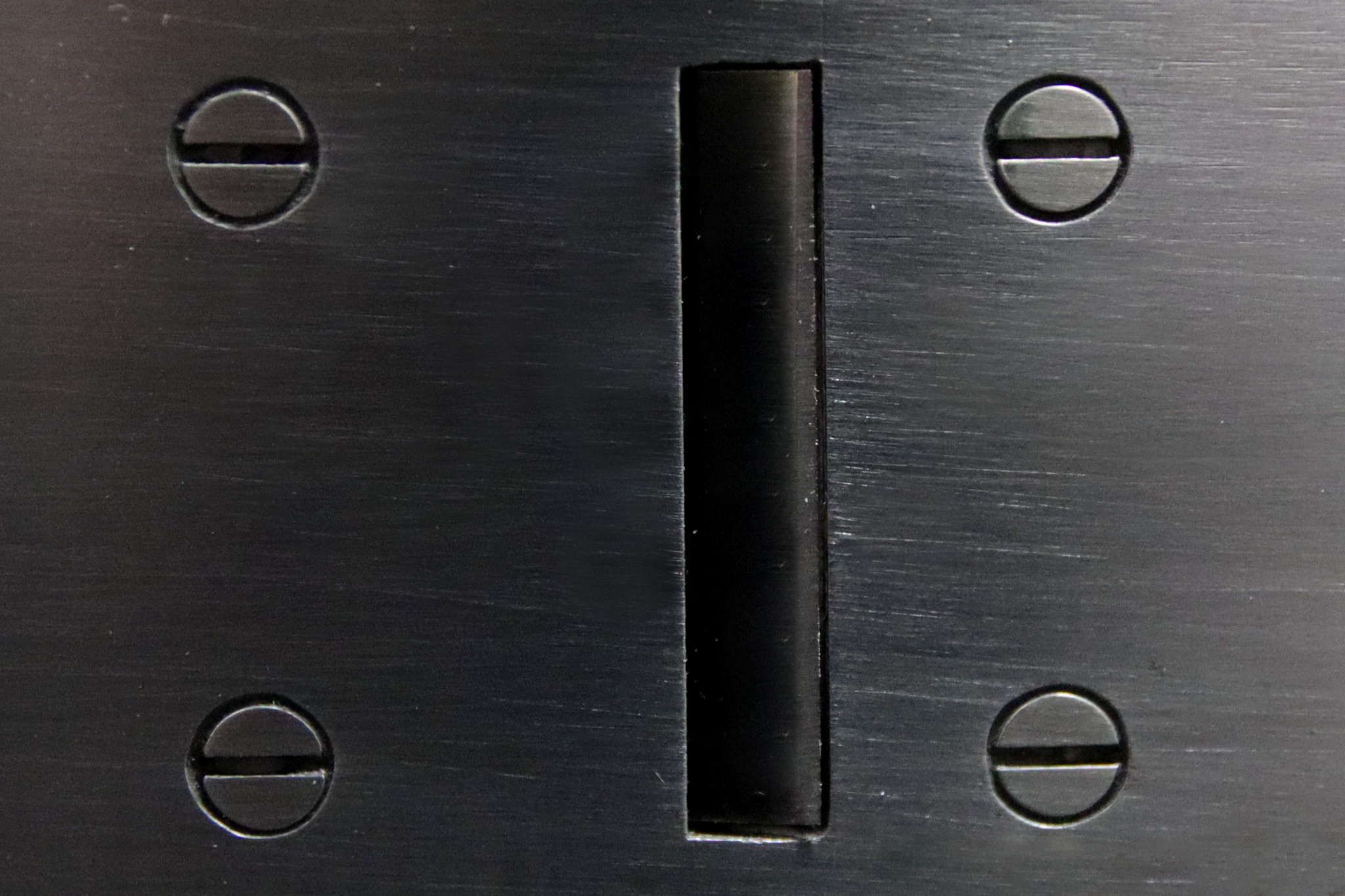 Close up view of a hand plane sole showing a tight mouth and four clocked screws.