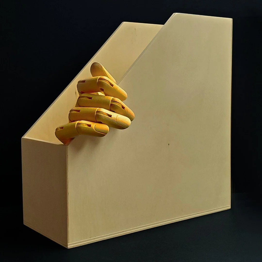 Baltic birch magazine file holder with an artist hand inside. 