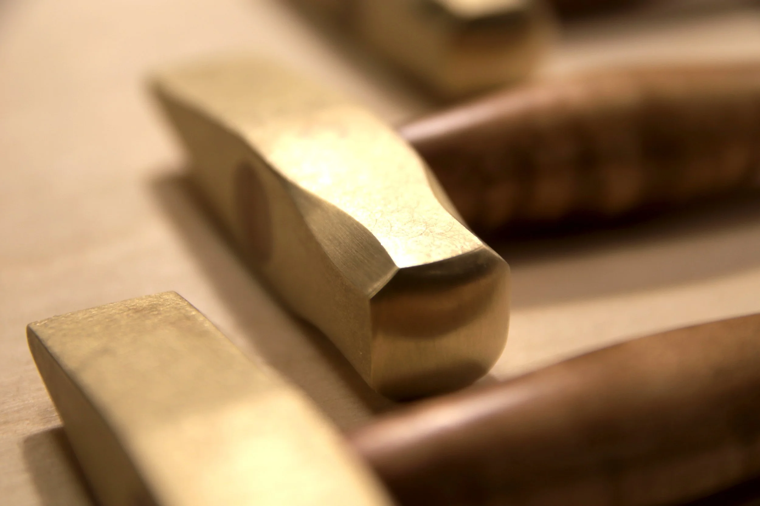 Close-up of the brass hammer head showing the smooth face.