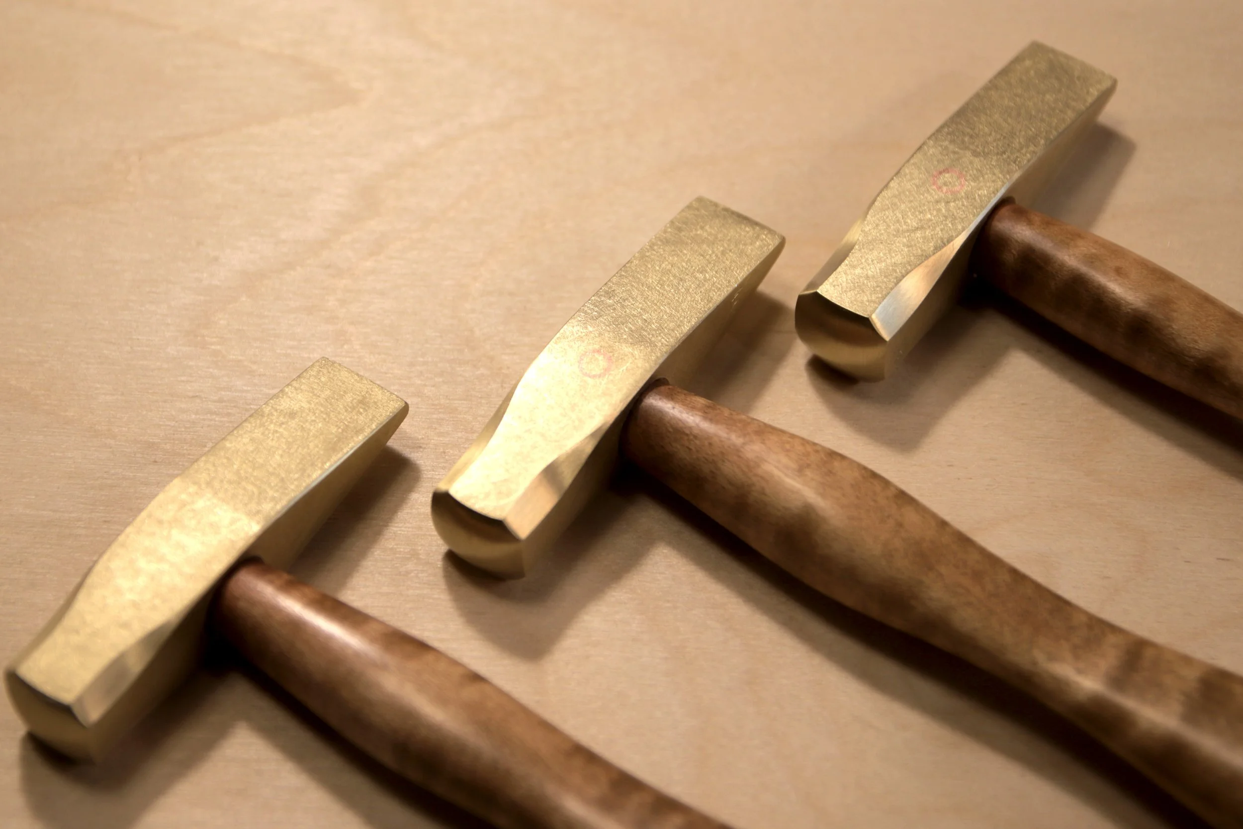 Three brass hammers with curly maple handles 