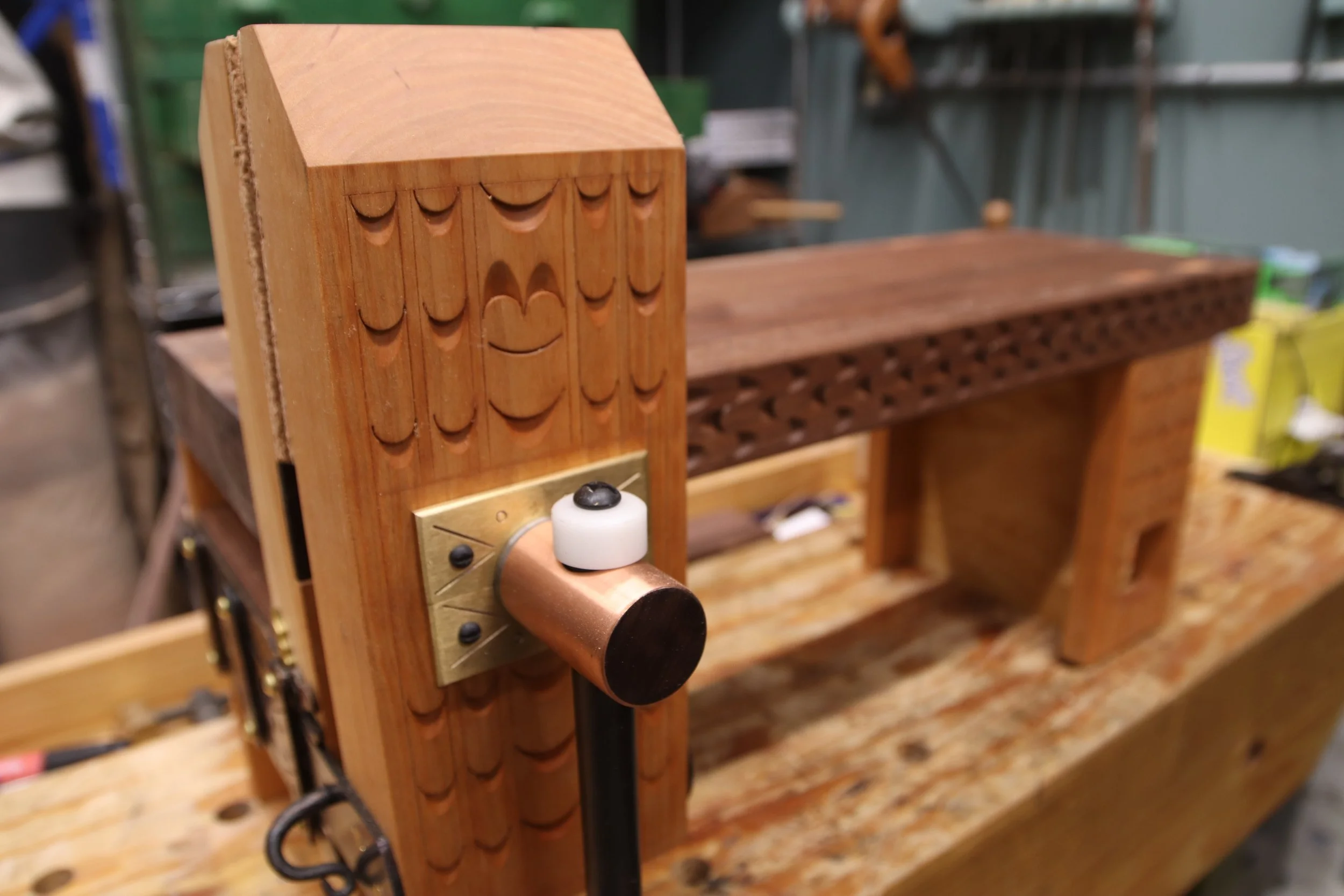 Close-up of a mini-workbench sitting on top of a full sized workbench