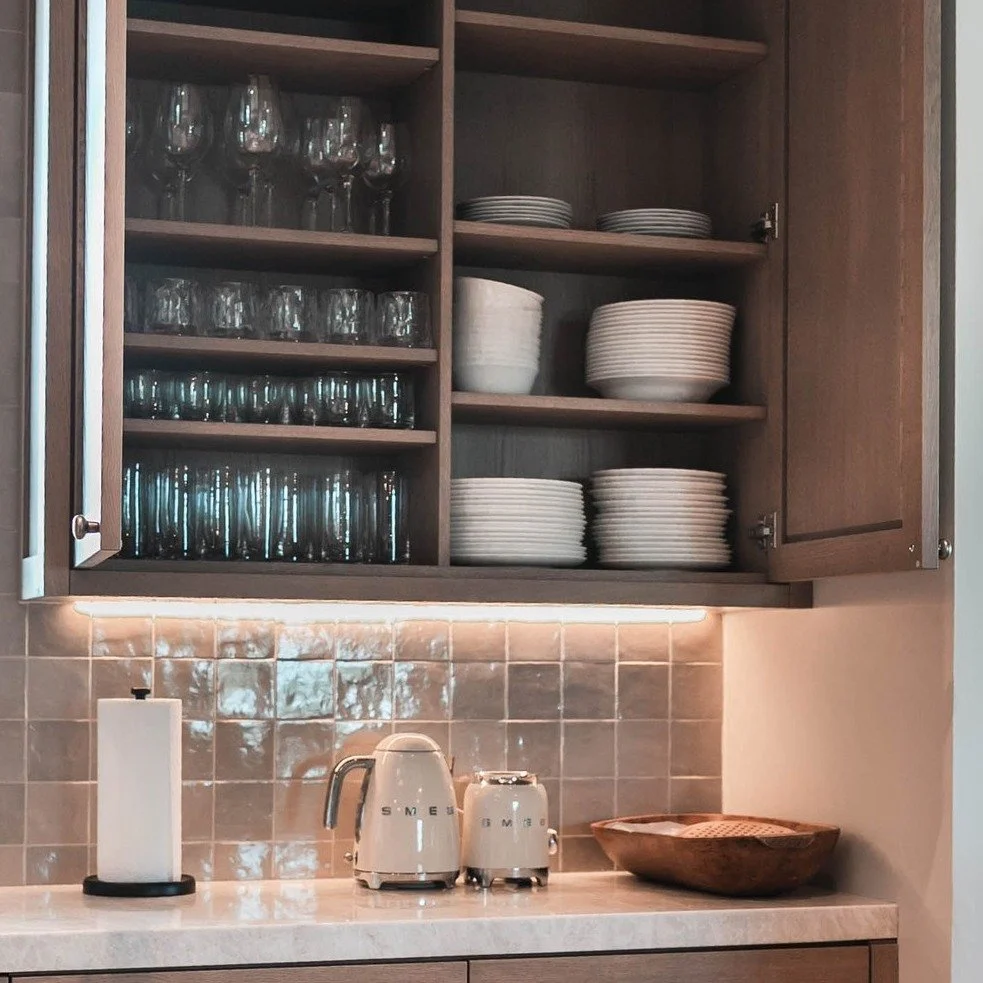 Every plate in its place.

Blending rustic beams with modern storage, Hilltop Hideaway is a study in contrasts.  Custom shelving was designed to fit the homeowner&rsquo;s dinnerware collection, right down to wine glasses. 

Would you choose open shel