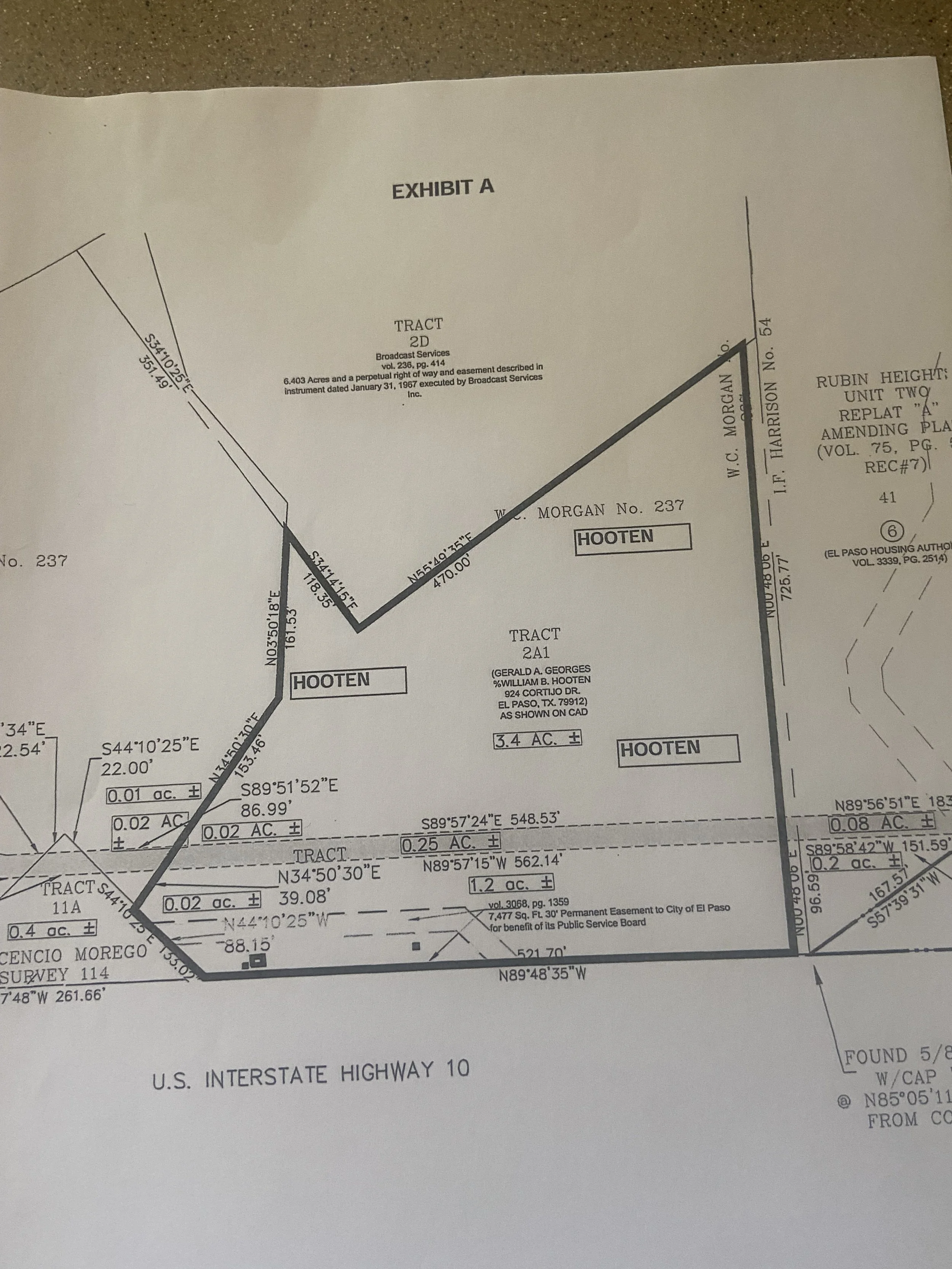 Land survey map labeled 'Exhibit A' showing various tracts and measurements near U.S. Interstate Highway 10, including areas designated as 'HOOTEN' and labeled tracts with acreage and coordinates.