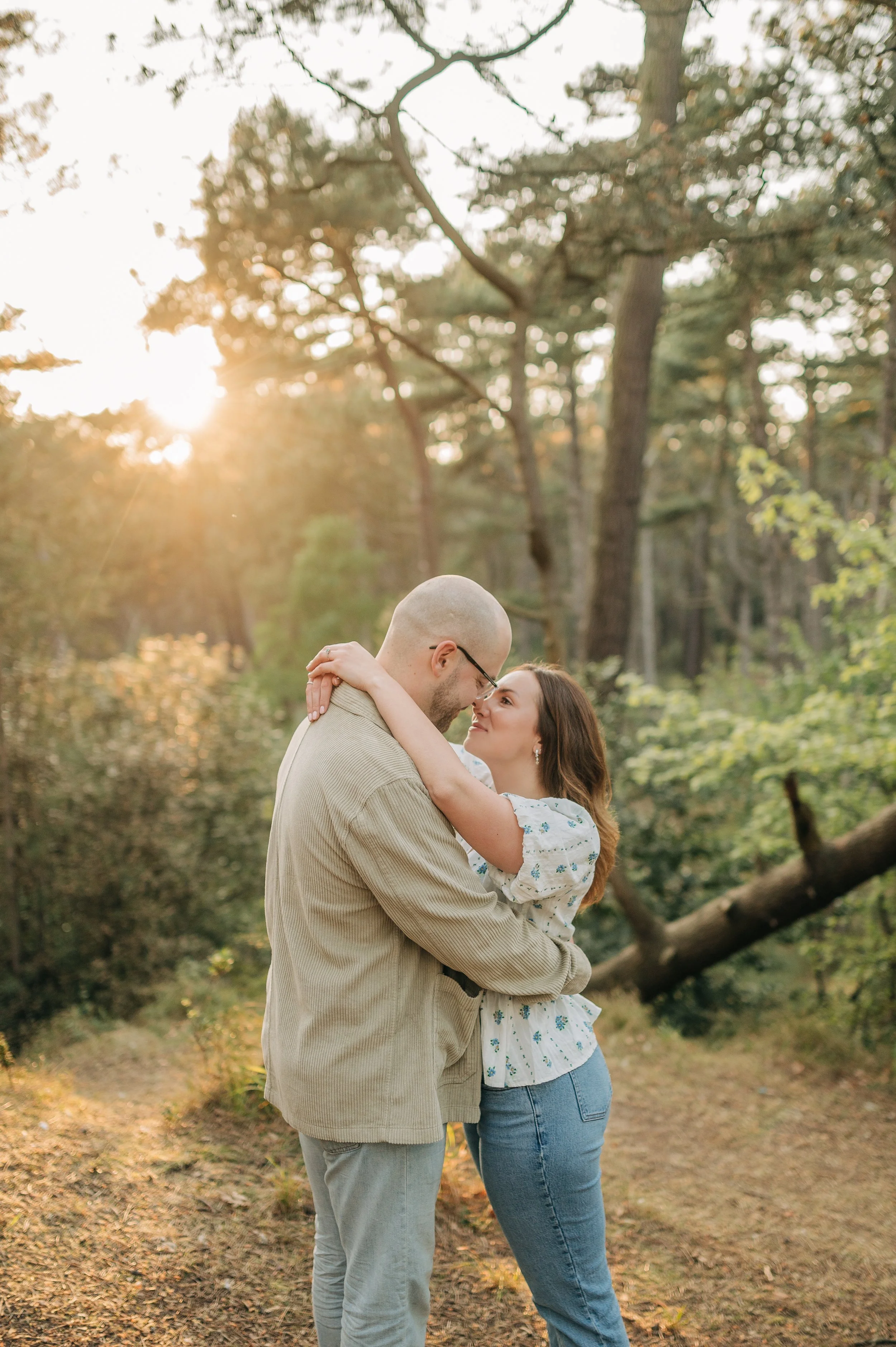 Norfolk Wedding Photographer.  A couple embracing in a forest at sunset.