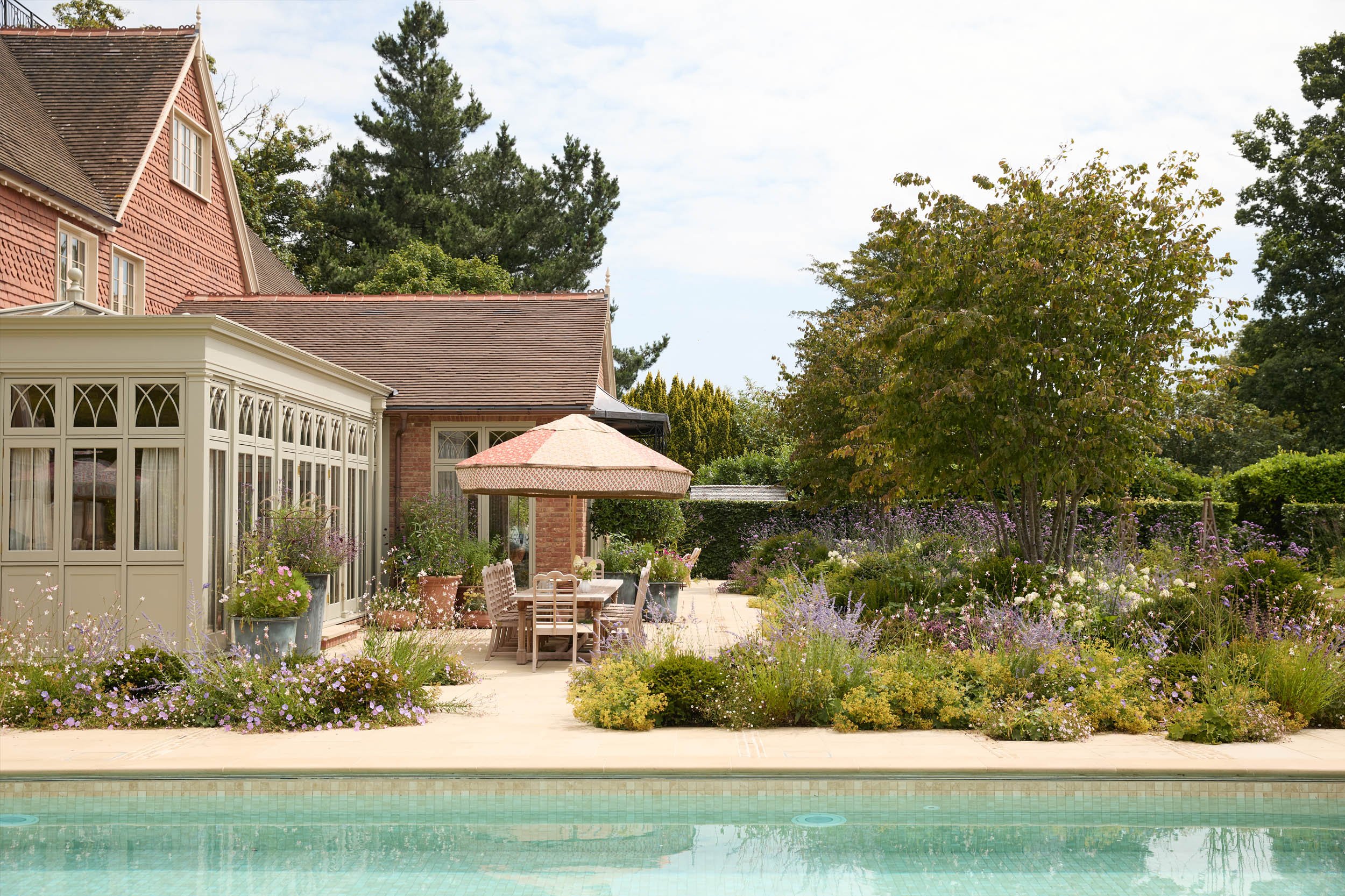 English counry home with swimming pool and lush garden