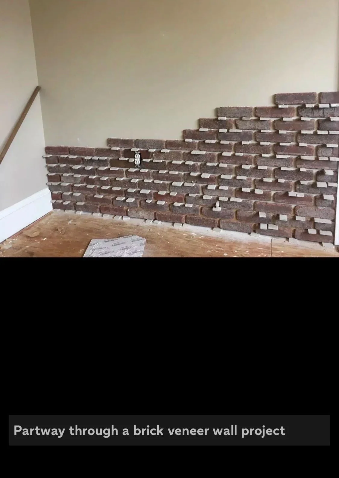 Installing brick veneer in man cave.