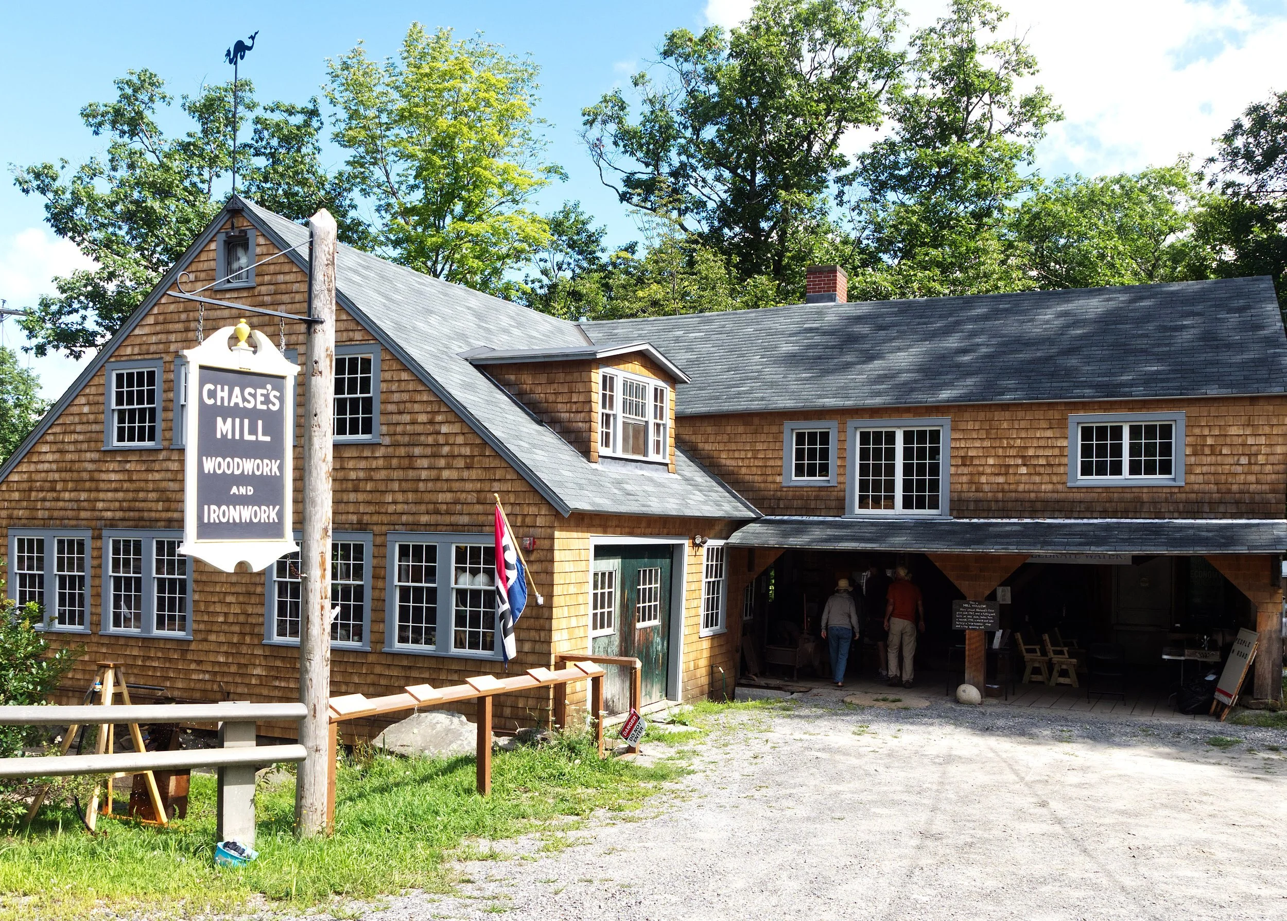Chase's Mill building with woodwork and ironwork sign, New Hampshire