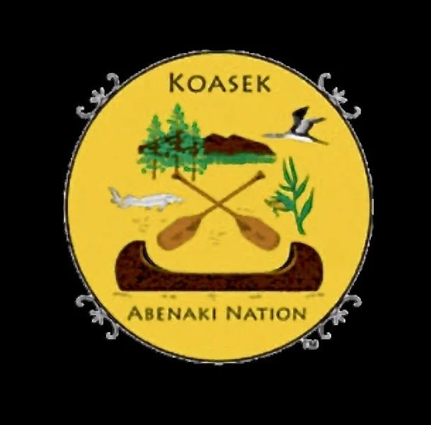 Emblem of the Koasek Abenaki Nation with canoe, paddles, fish, bird, and trees, set against a yellow background.