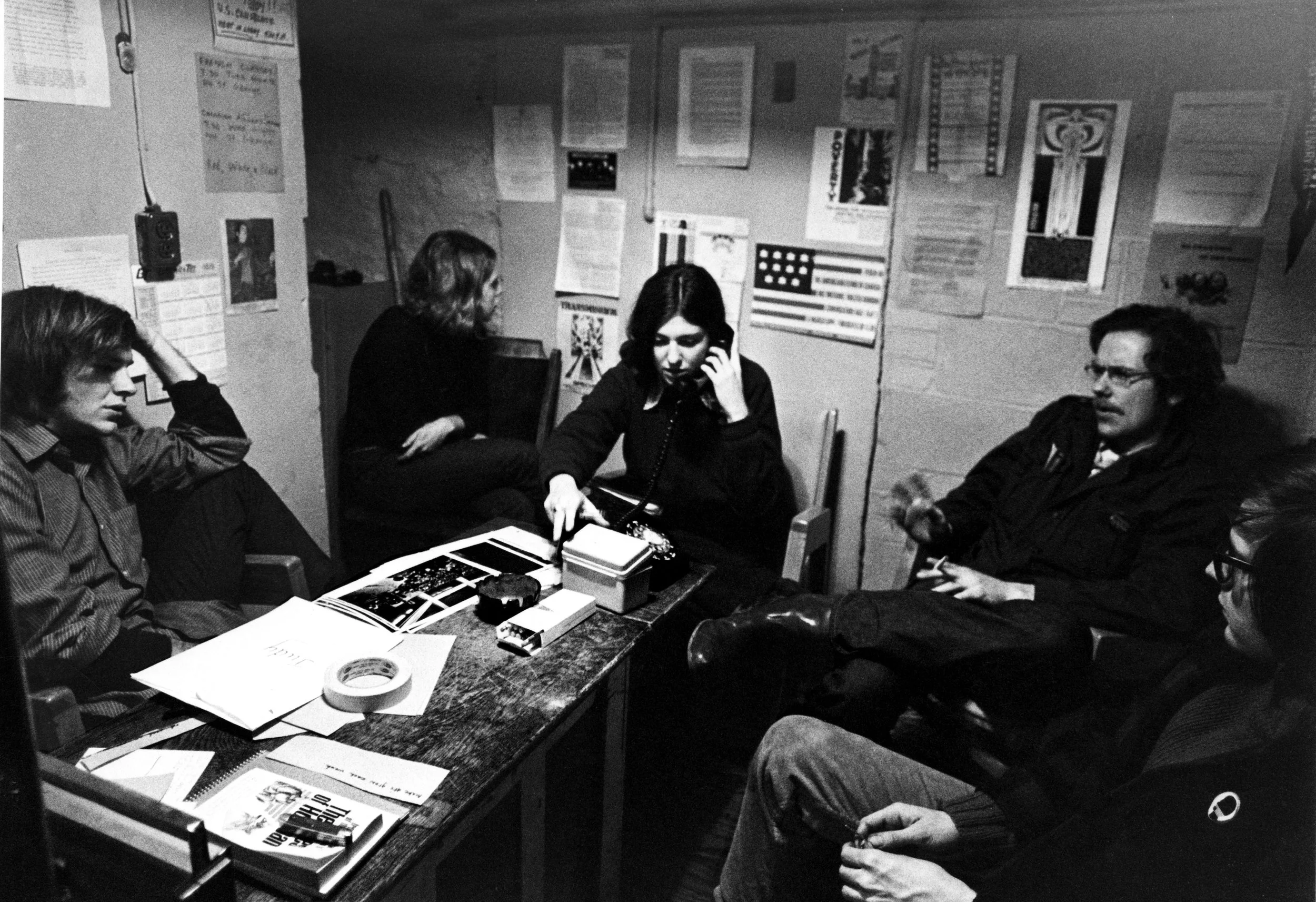 Five young people sitting and talking intently, Mark Satin (left), director of the Toronto Anti-Draft Programme, counseling American draft evaders, 1967