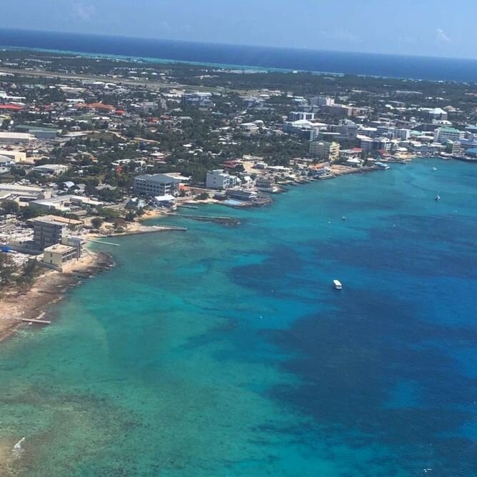 A quick snapshot of our island's capital! Can you see our shop in this picture?🤔
&bull;
&bull;
&bull;
&bull;
#cihelicopters 
#aerialview 
#georgetown 
#livinglifeatfullthrottle