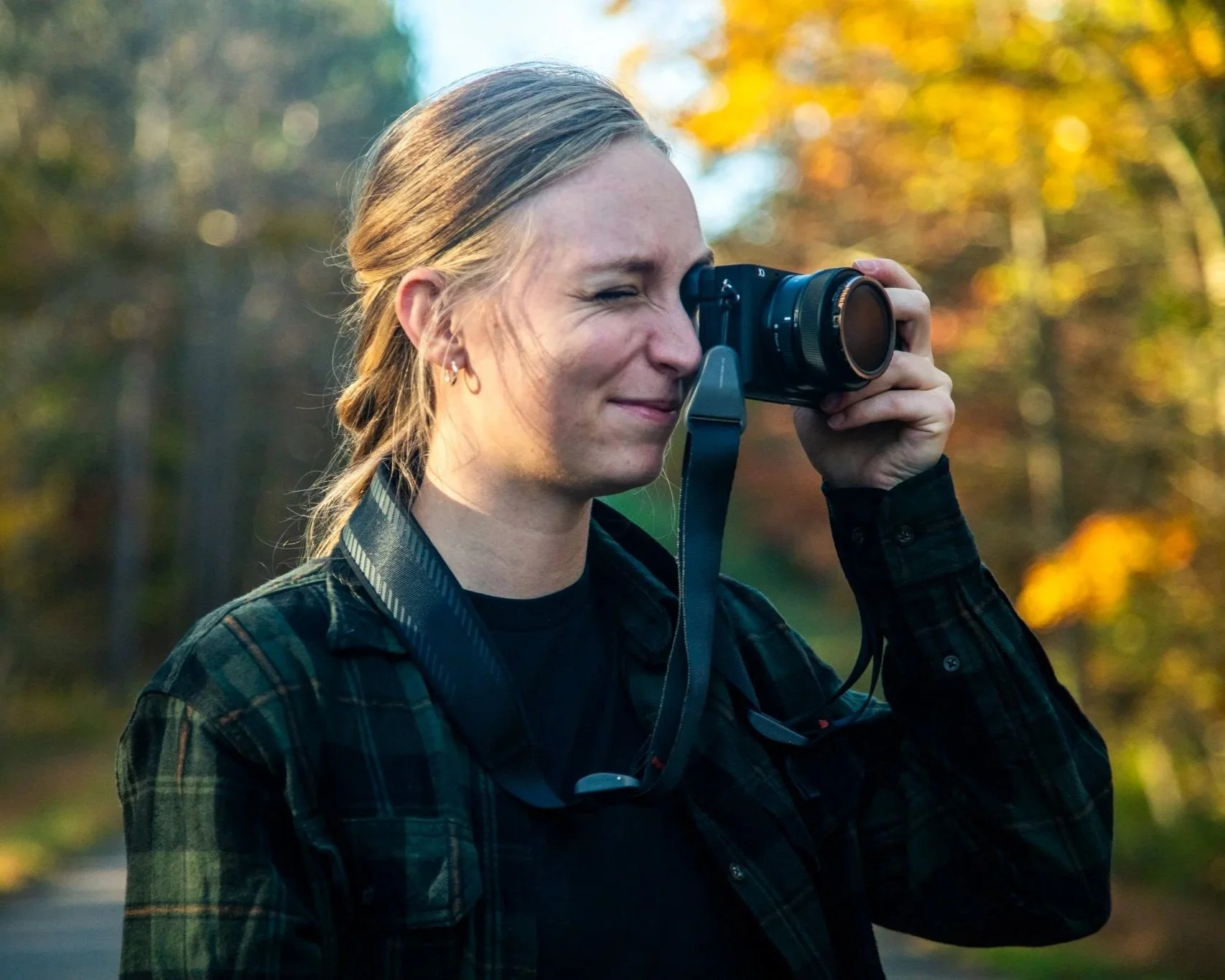 Jana, Pittsburgh filmmaker and photographer, holds a camera to her eye