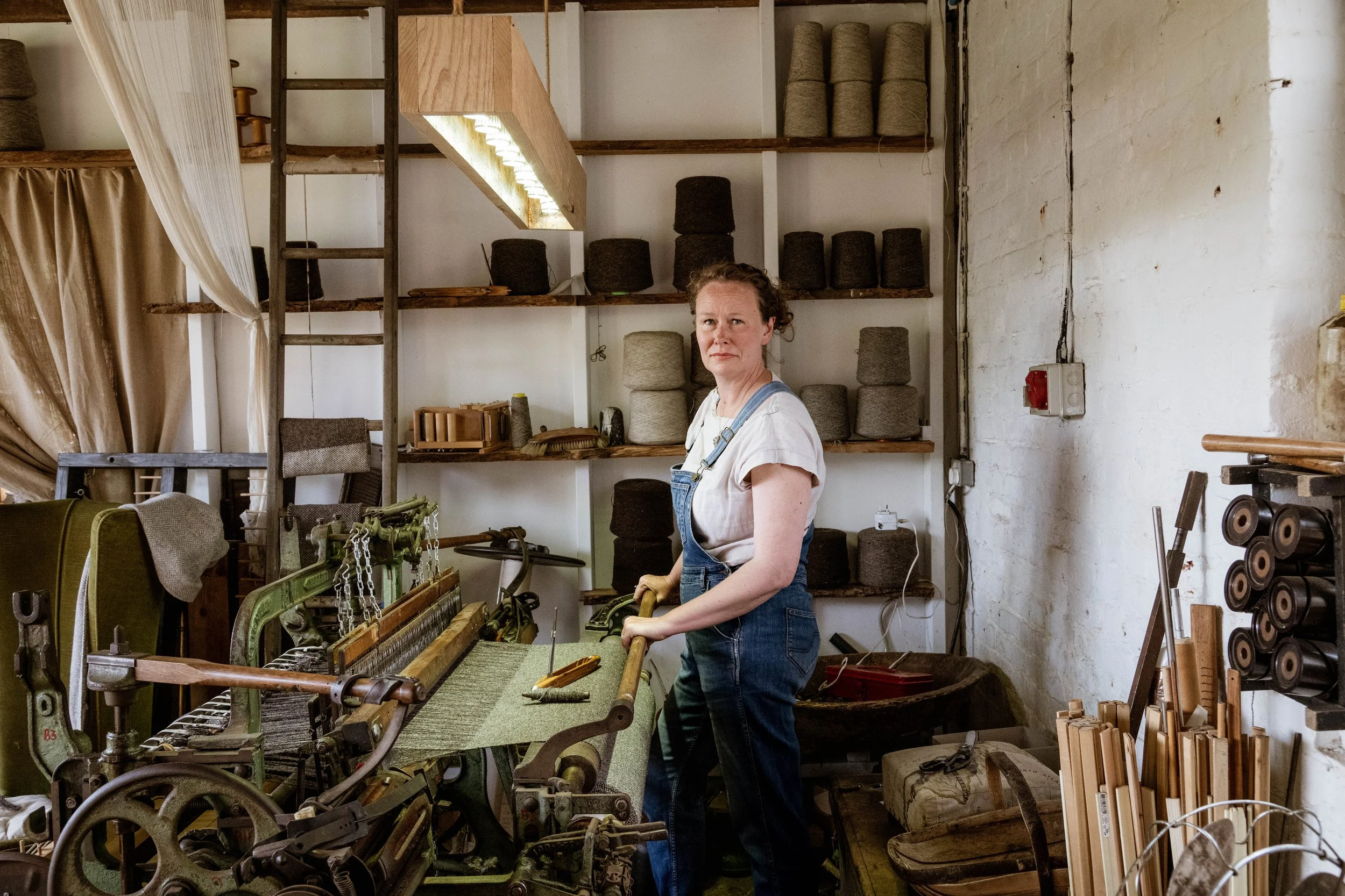 James & Katie are Mabel & Co  and are multi skilled artisans, working in weaving, ceramics, photography, letterpress printing. Katie  is shown at the restored treadle powered weaving loom weaving a blanket