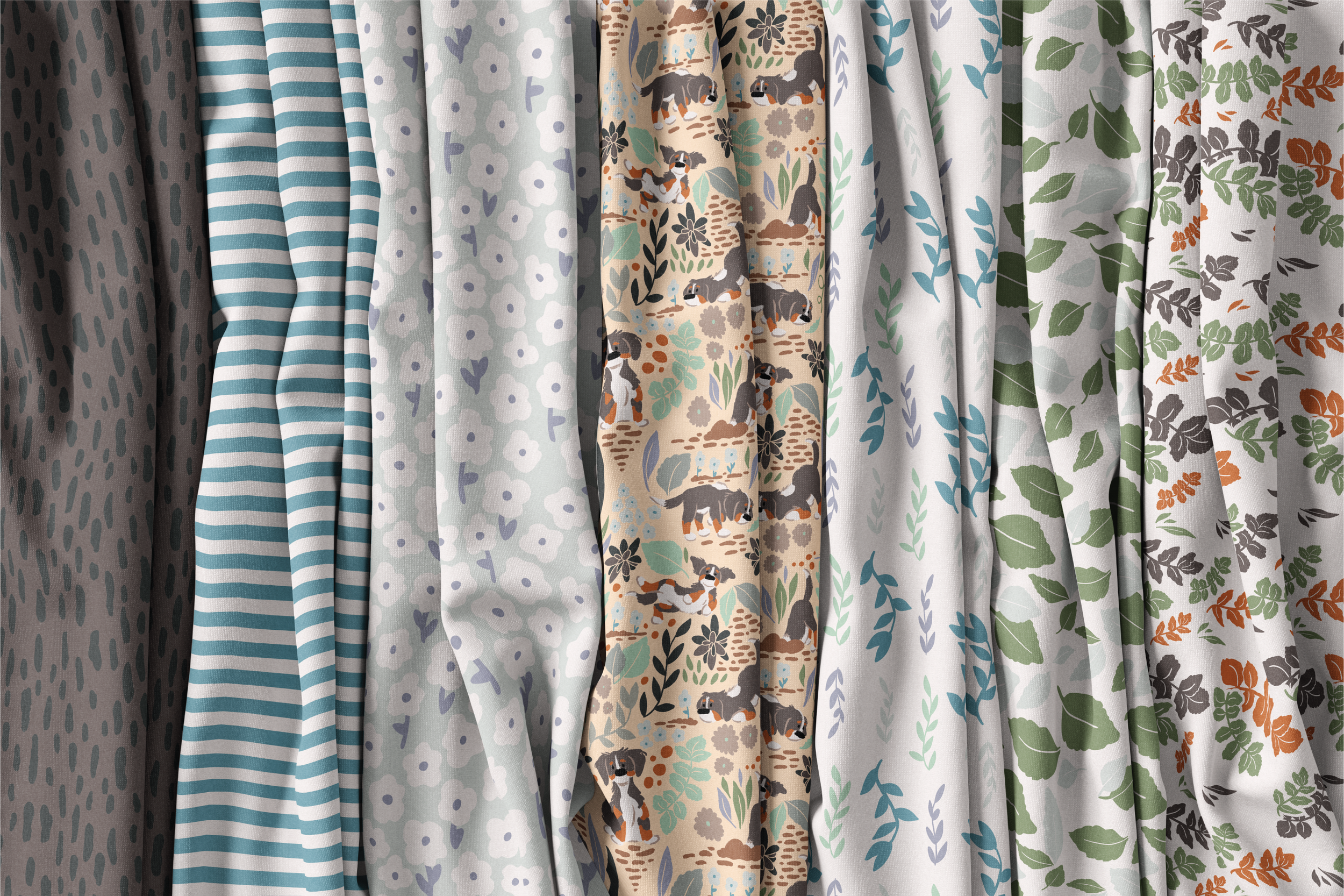 A display of fabric bolts with various patterned textiles, including animal and floral designs. Designed by Berlynn Burns with the Burns Creative. The pattern collection is Bernie's Backyard, a puppy Bernese Mountain Dog