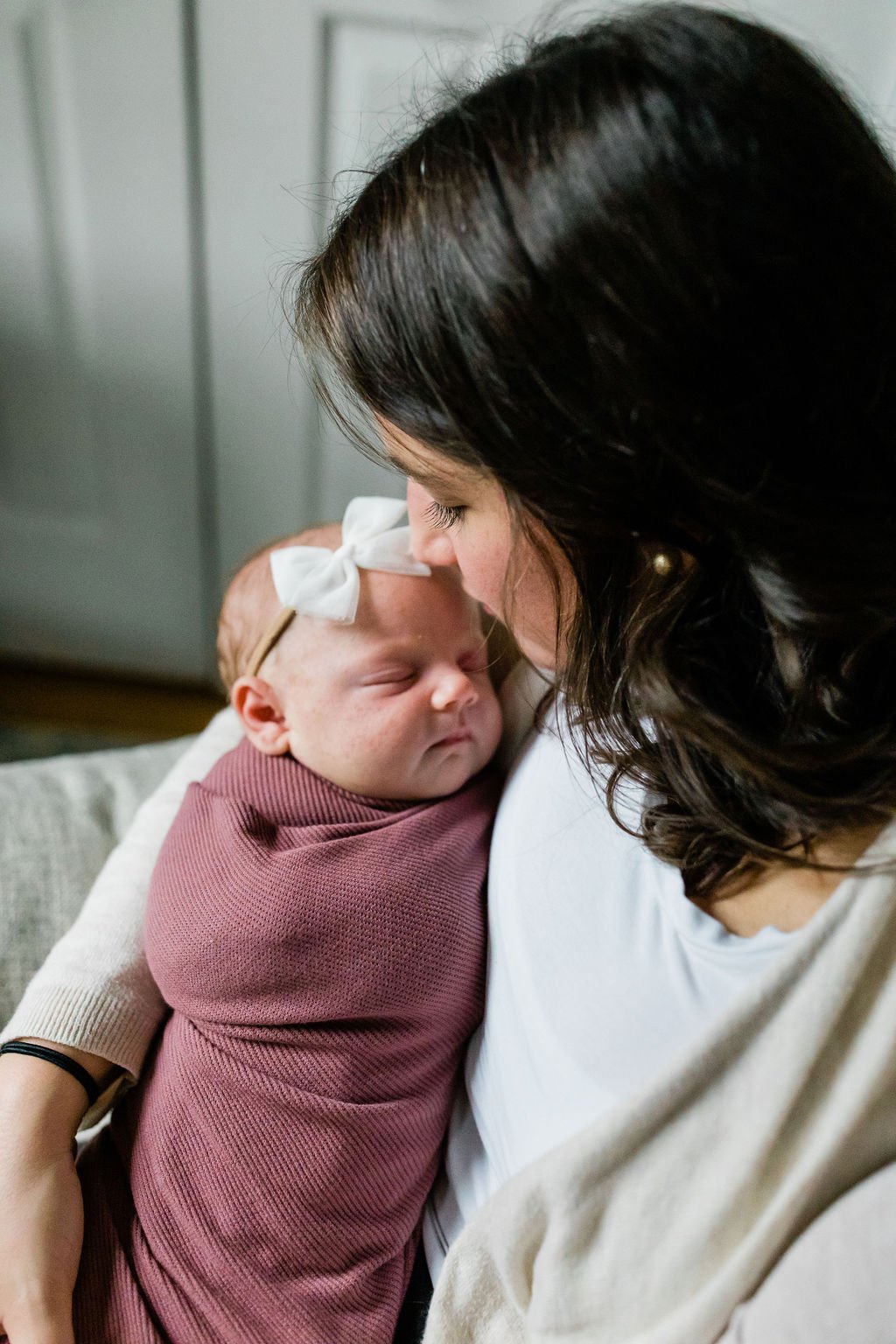 newborn baby with mom and dad indoors, taken by outdoor family photographer in Northern Virginia