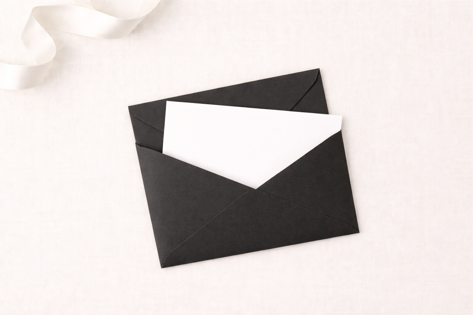 Elegant black envelope with white card.png