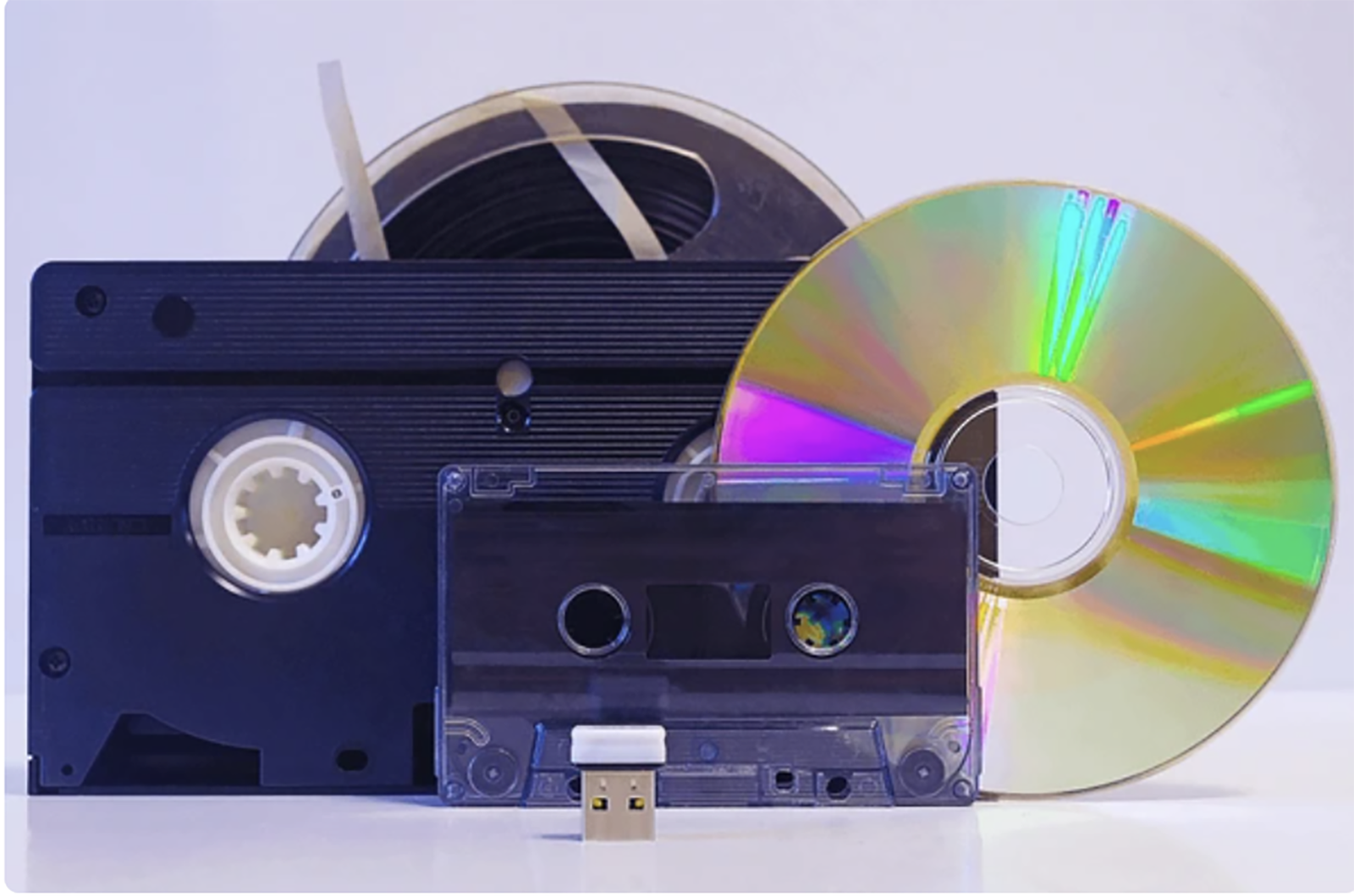 Old media: a VHS tape, an audio cassette, a CD and a USB stick