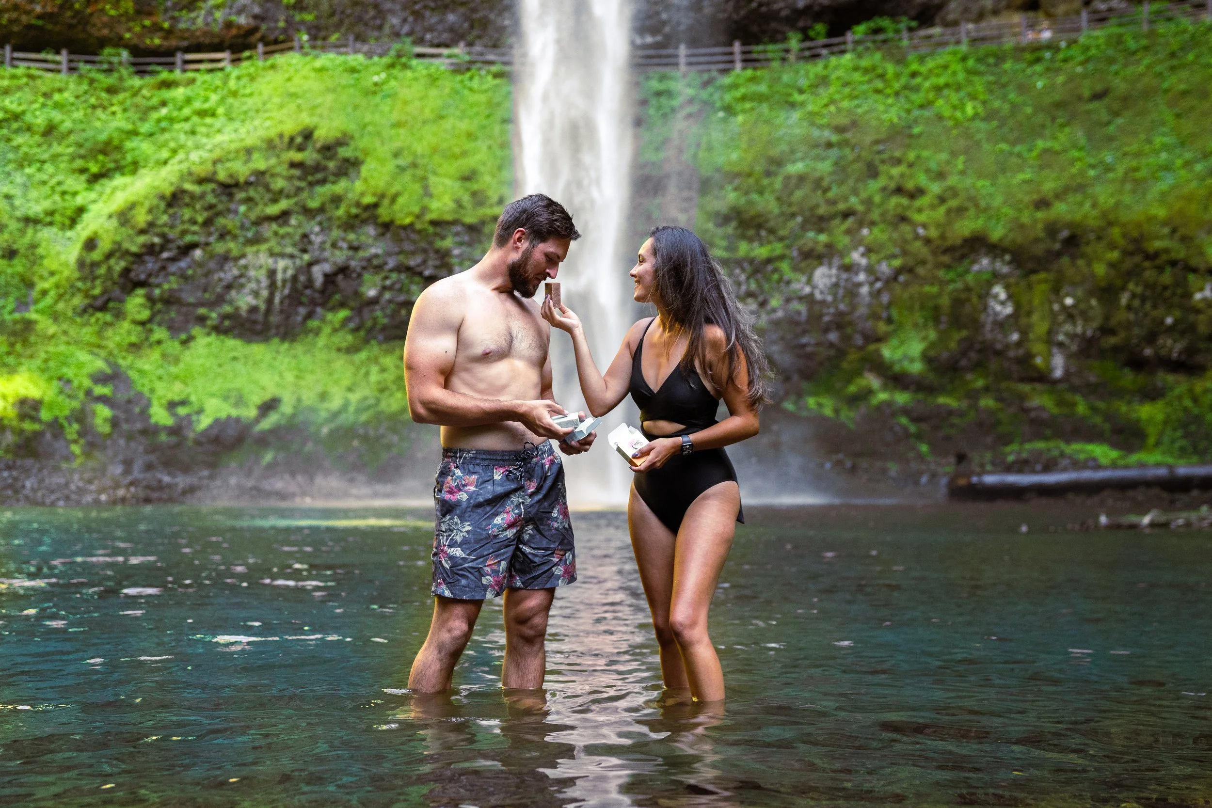 A close-up of a field of daisies with white petals and yellow centers during sunset.