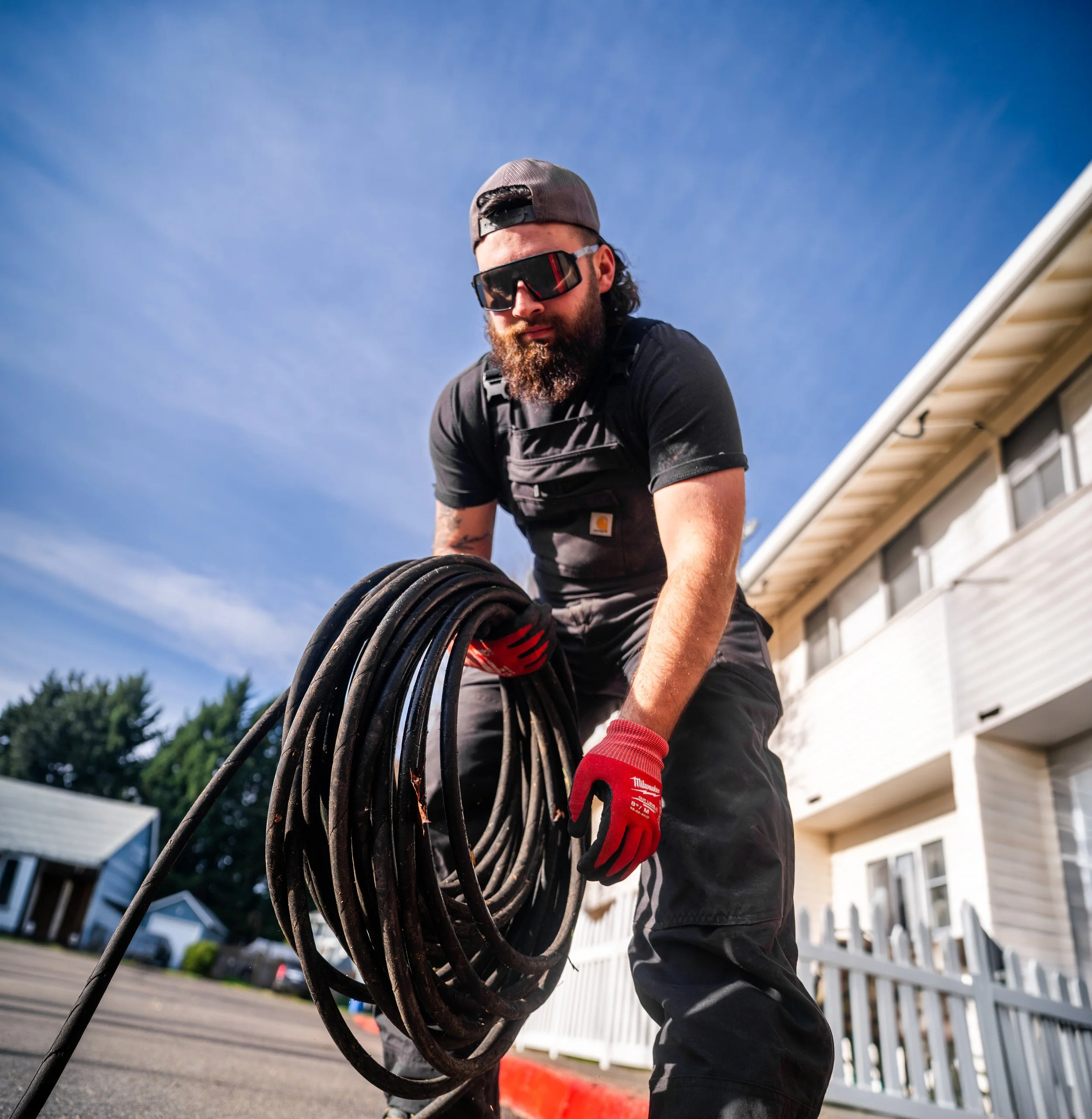 Modern house with pool, outdoor lounge chairs, and surrounding desert landscape in the late afternoon.