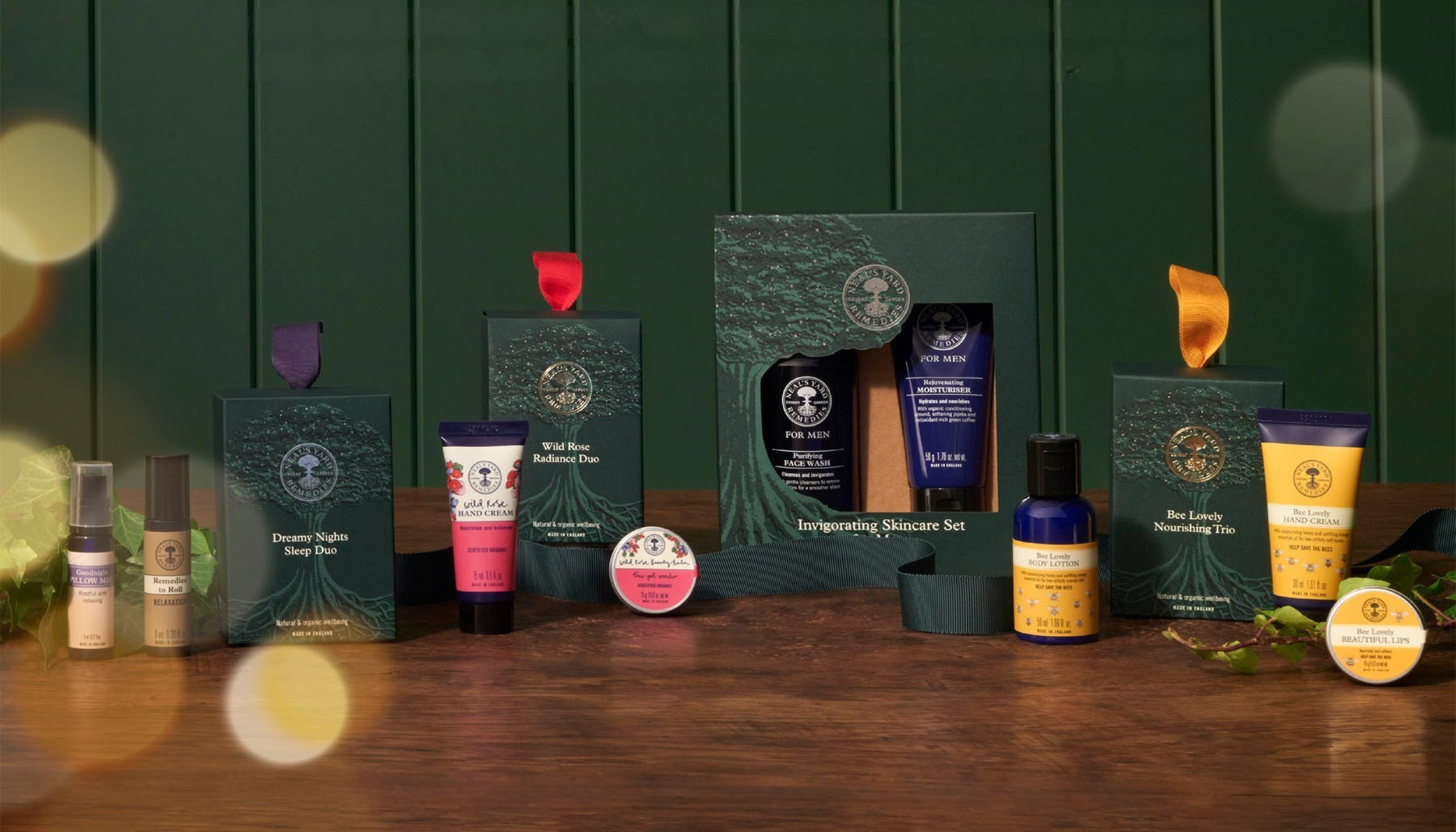 Neal's Yard Remedies Christmas campaign image of festive beauty and skincare products with holiday wrapping and soft bokeh lights.
