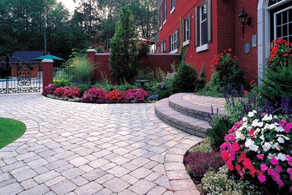 Brick Paver Patio; Oldworld (Oaks) Brick Paver Patio with Custom Rounded Steps, with soldier trim for garden beds, custom perennials and arborvitaes installation, and Landscape Lighting, designed & installed in Rochester Hills, Michigan.