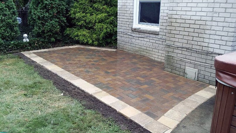 Brick Paver Patio; Multi-colored Brick Paver Patio with a soldier border, custom designed, in Royal Oak, Michigan. Installed Hot Tub.