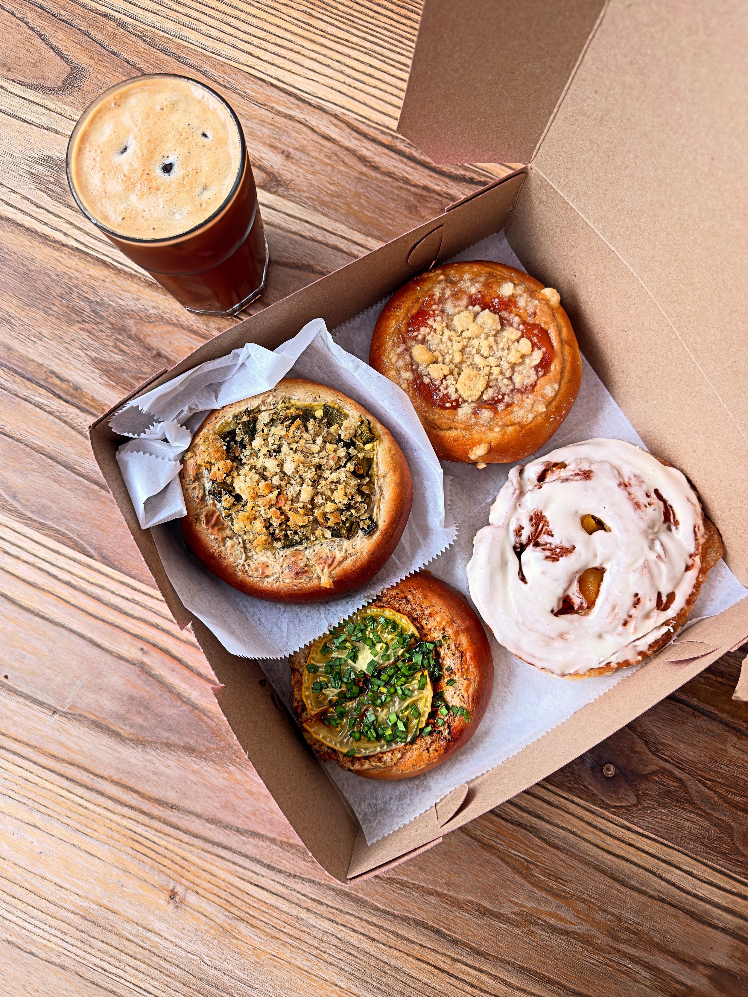 A box of Florosa sweet and savory pastries, featuring the weekend specials that shift and change with the seasons. Never fear, the pineapple fritter is on the menu forever.
