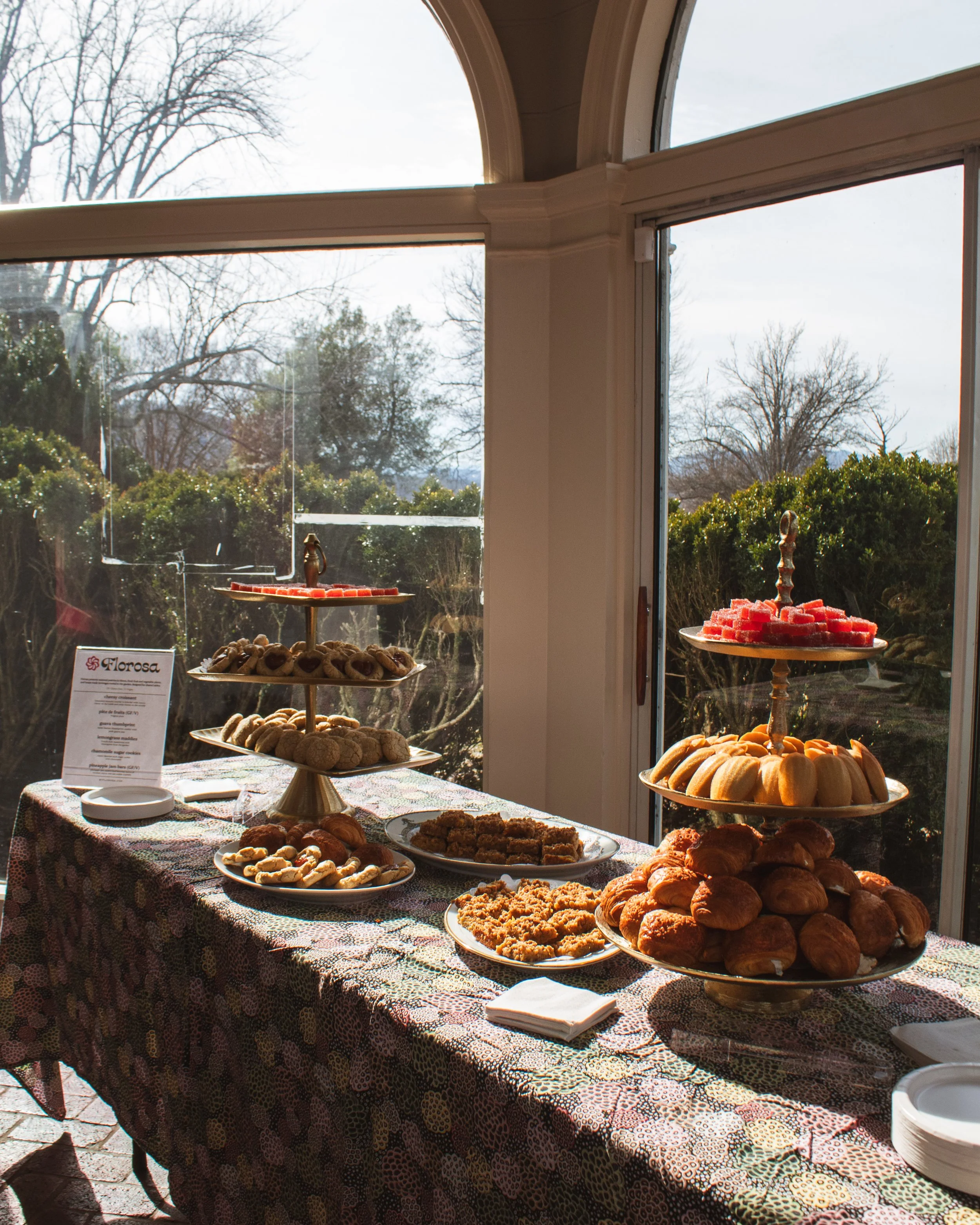 Florosa pastry catering setup for UVA at Kluge Ruhe museum, items displayed for guests to enjoy