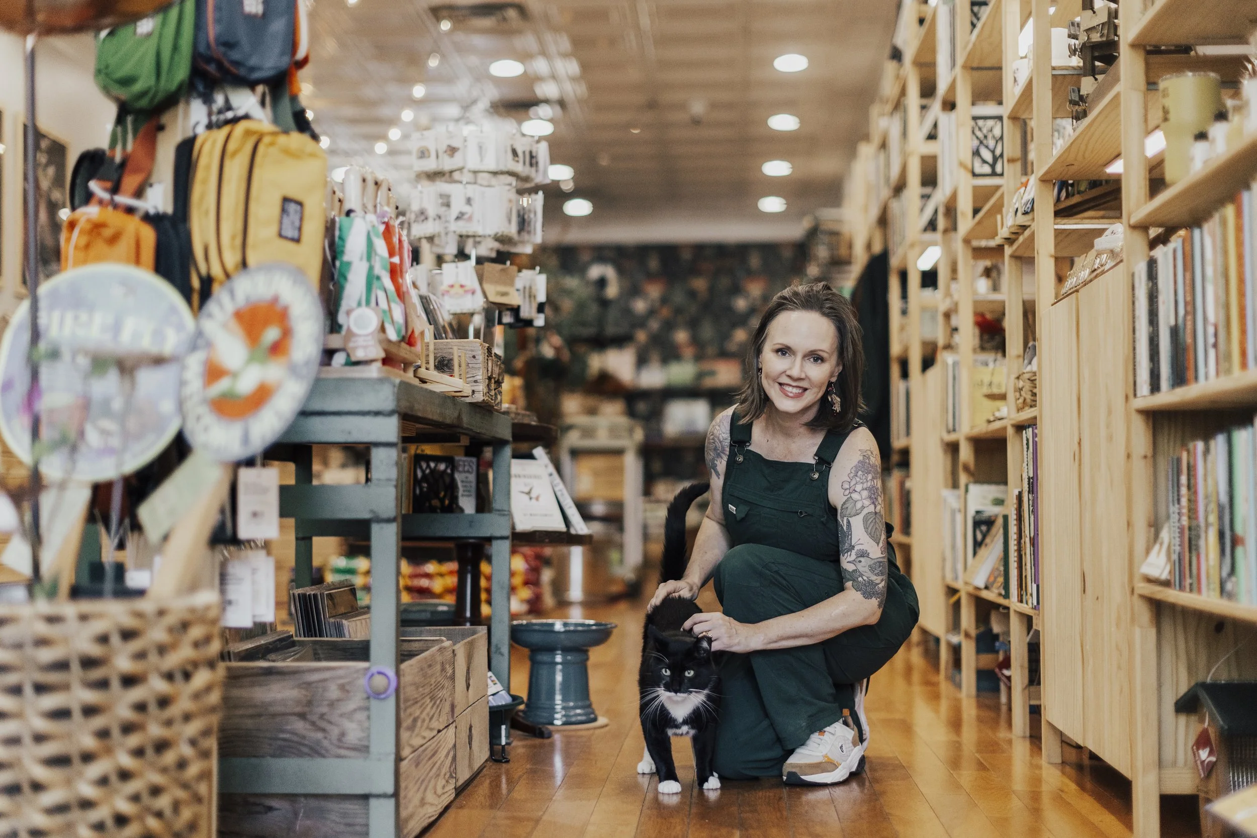 Kara with the shop cat, Loon, welcoming you to the store!