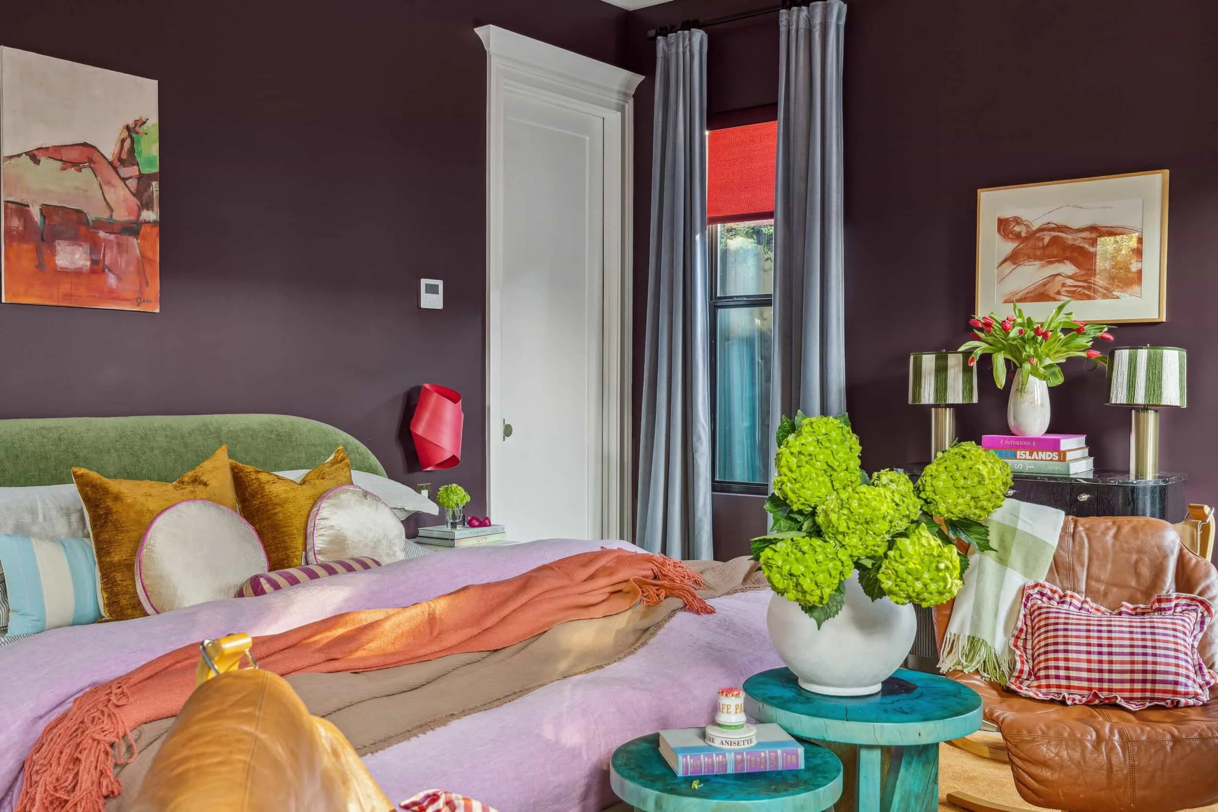 COLOR OUTSIDE THE LINES  This Austin bedroom suite was never meant to play it safe. We paired moody plum walls with a green velvet bed, layered textures and custom built-ins so the space feels personal, lived-in and organized. 