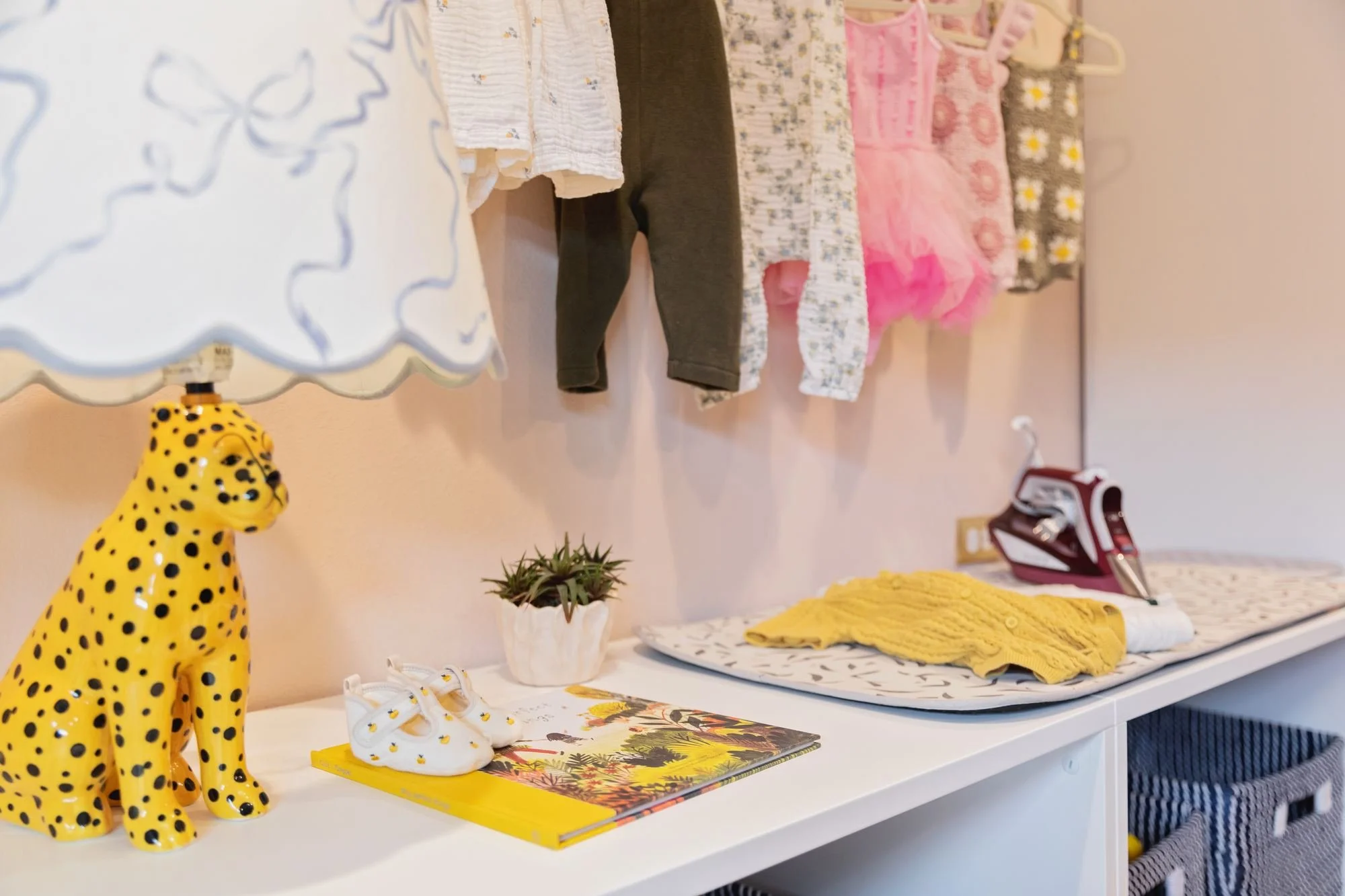 playroom-styling-cheetah-lamp-baby-shoes-book.jpg