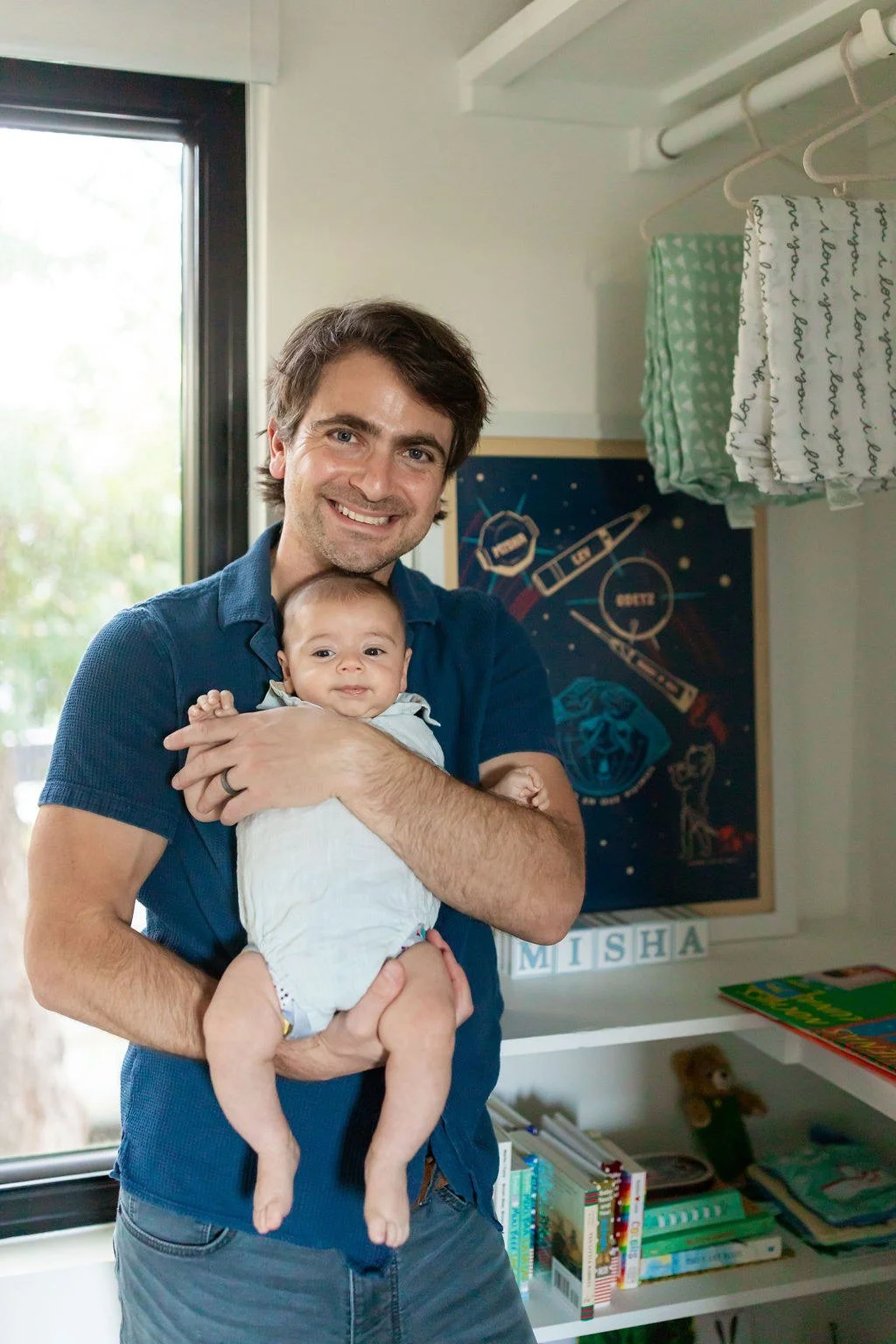 organized-nursery-closet-shelves-hanging-swaddles.jpg