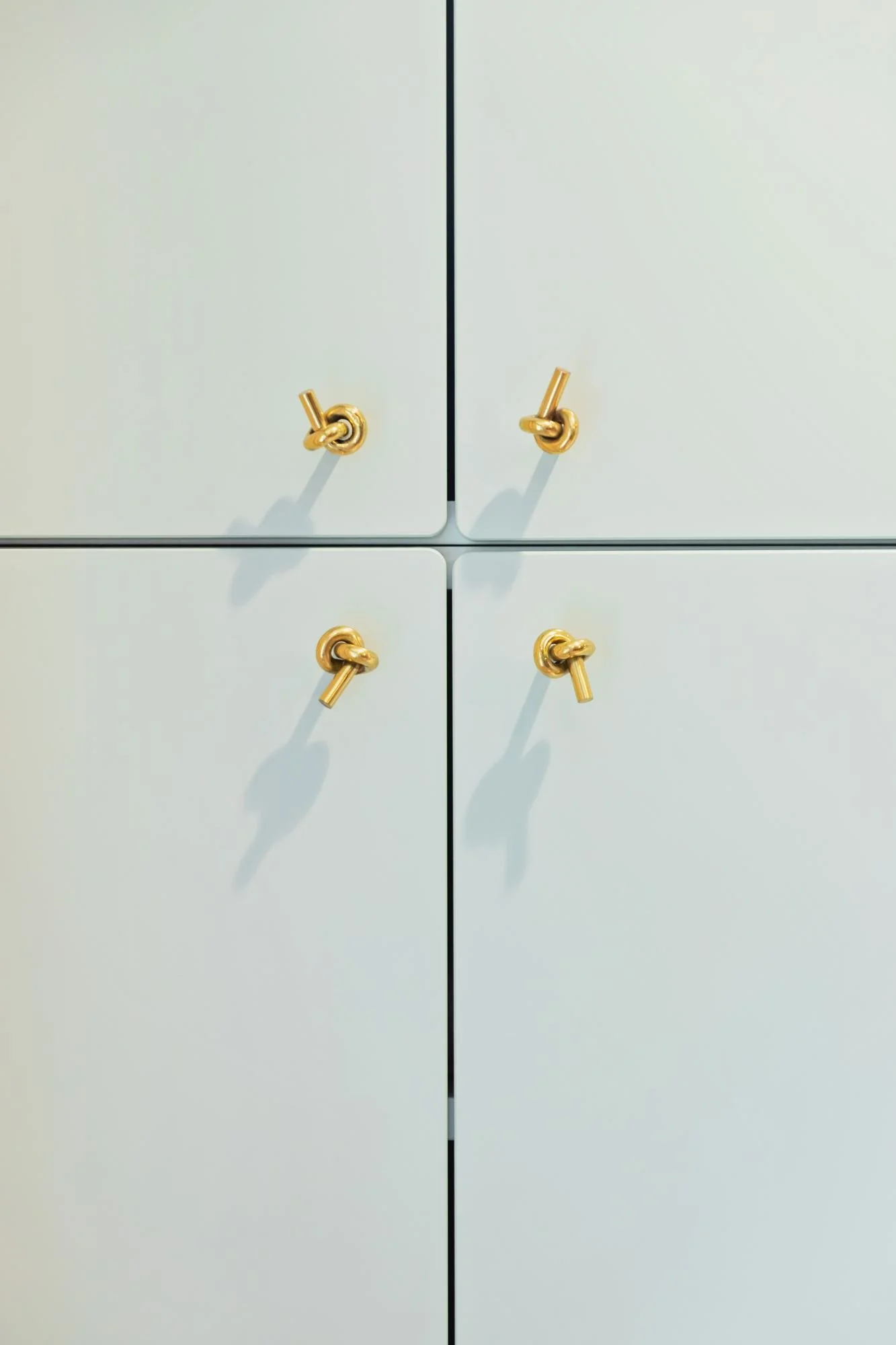 mint-cabinets-brass-knot-knobs-playroom-storage.jpg