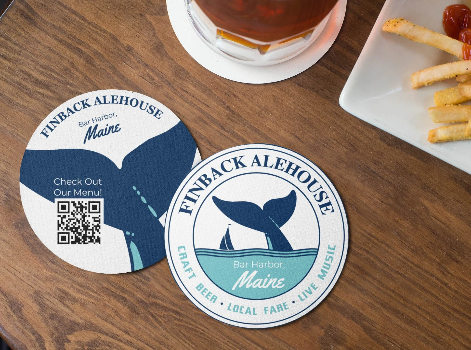 mockup-of-two-round-coasters-lying-on-a-wooden-table-by-some-fries-27802.jpg