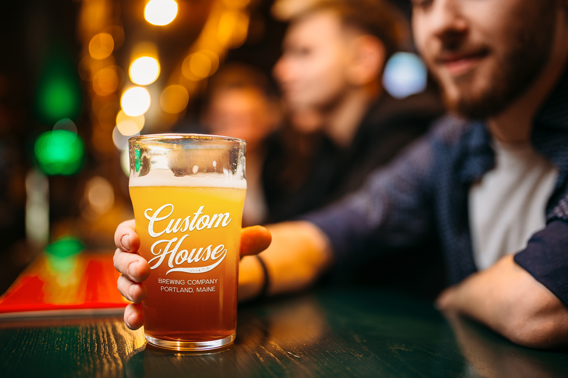 mockup-of-a-man-holding-a-beer-glass-at-a-bar-37322-r-el2.png