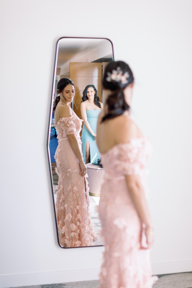  bride looking at her self in the mirror 