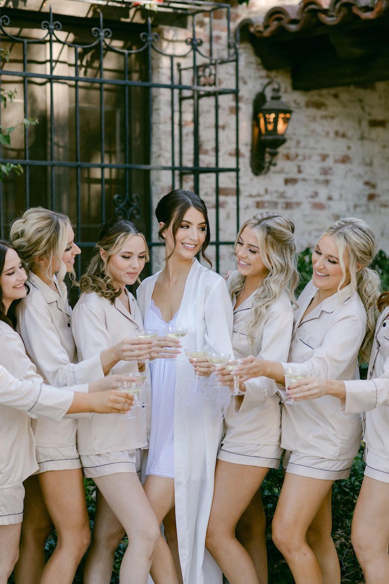 Bride and Bridal party toasting with champagne