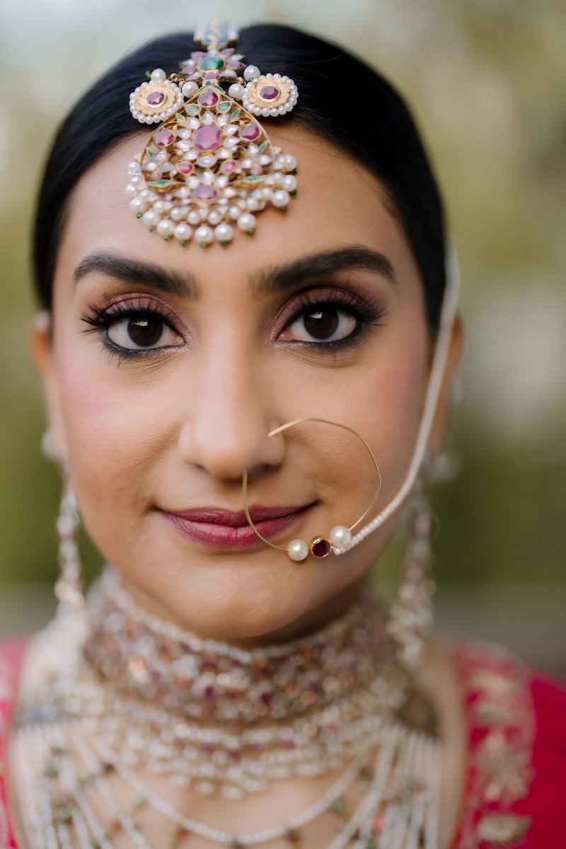  close up of indian bridal makeup and jewelry 