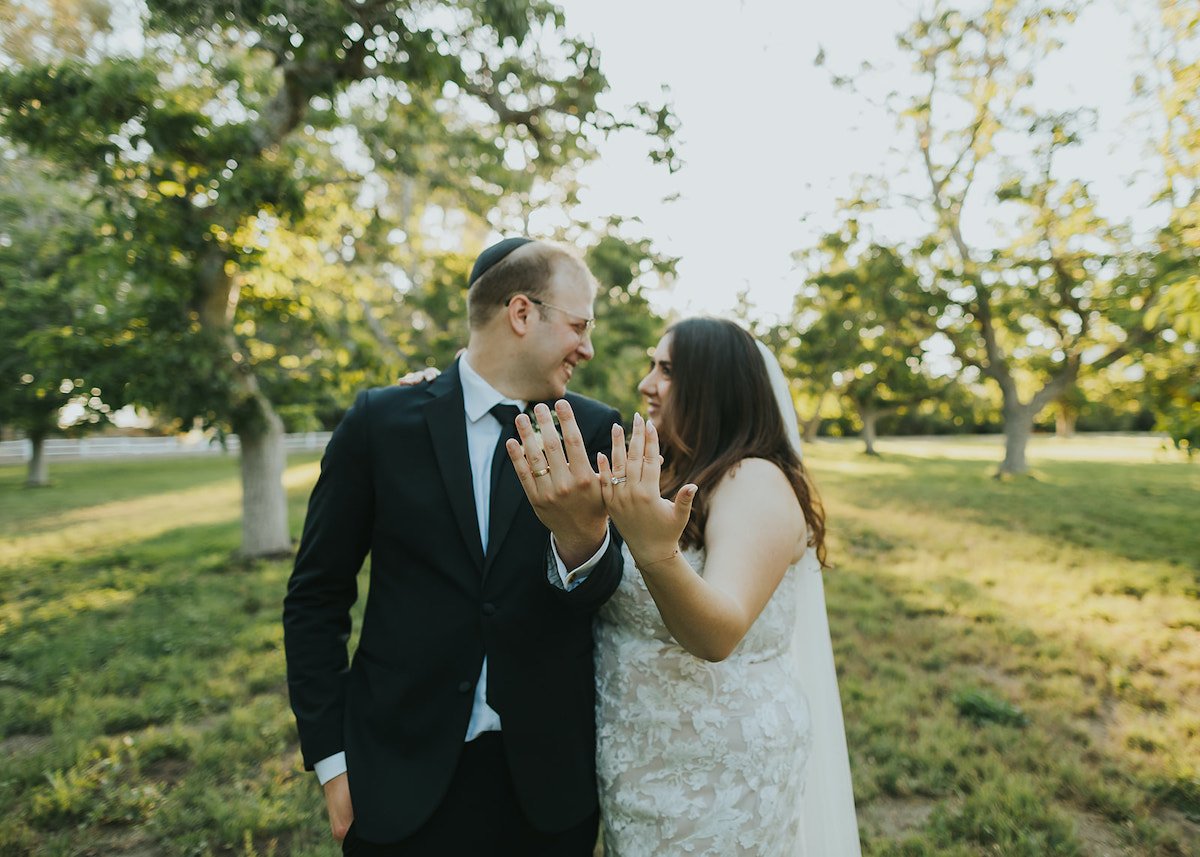  Bride and Groom showing off their rings 