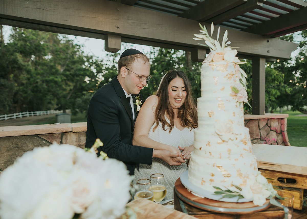  bride and groom cutting the cake 