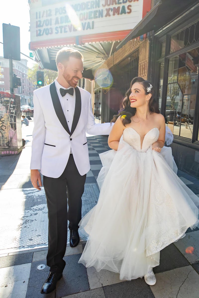  bride and groom in old hollywood glam walking through downtown los angeles 