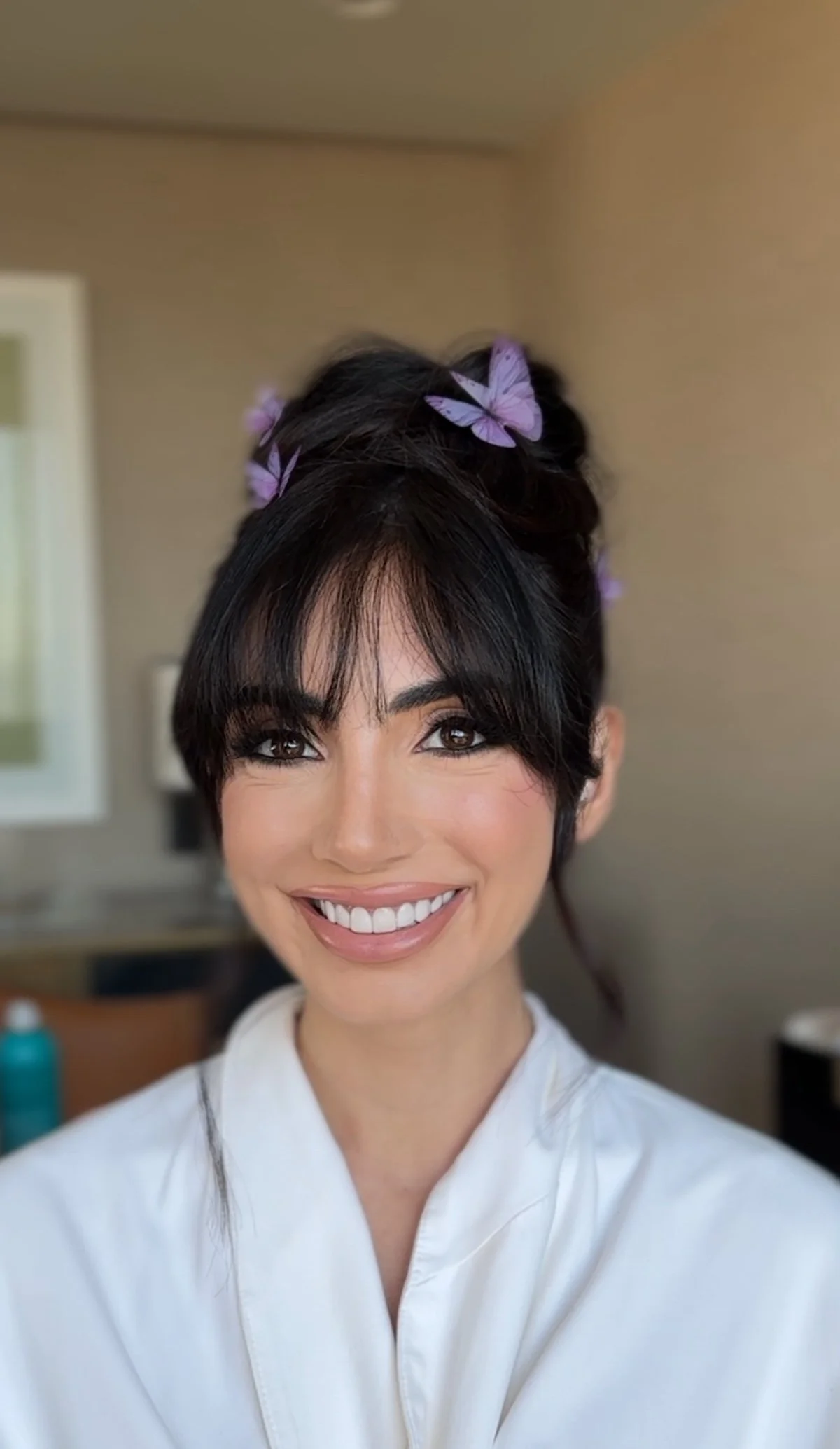 red carpet premiere nuetral makeup with glossy lip and dark black hair updo with accessories