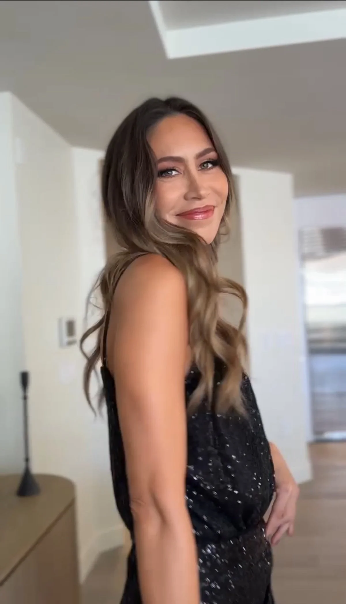 event bronzy soft glam makeup with pop of color on the lips and soft hair waves