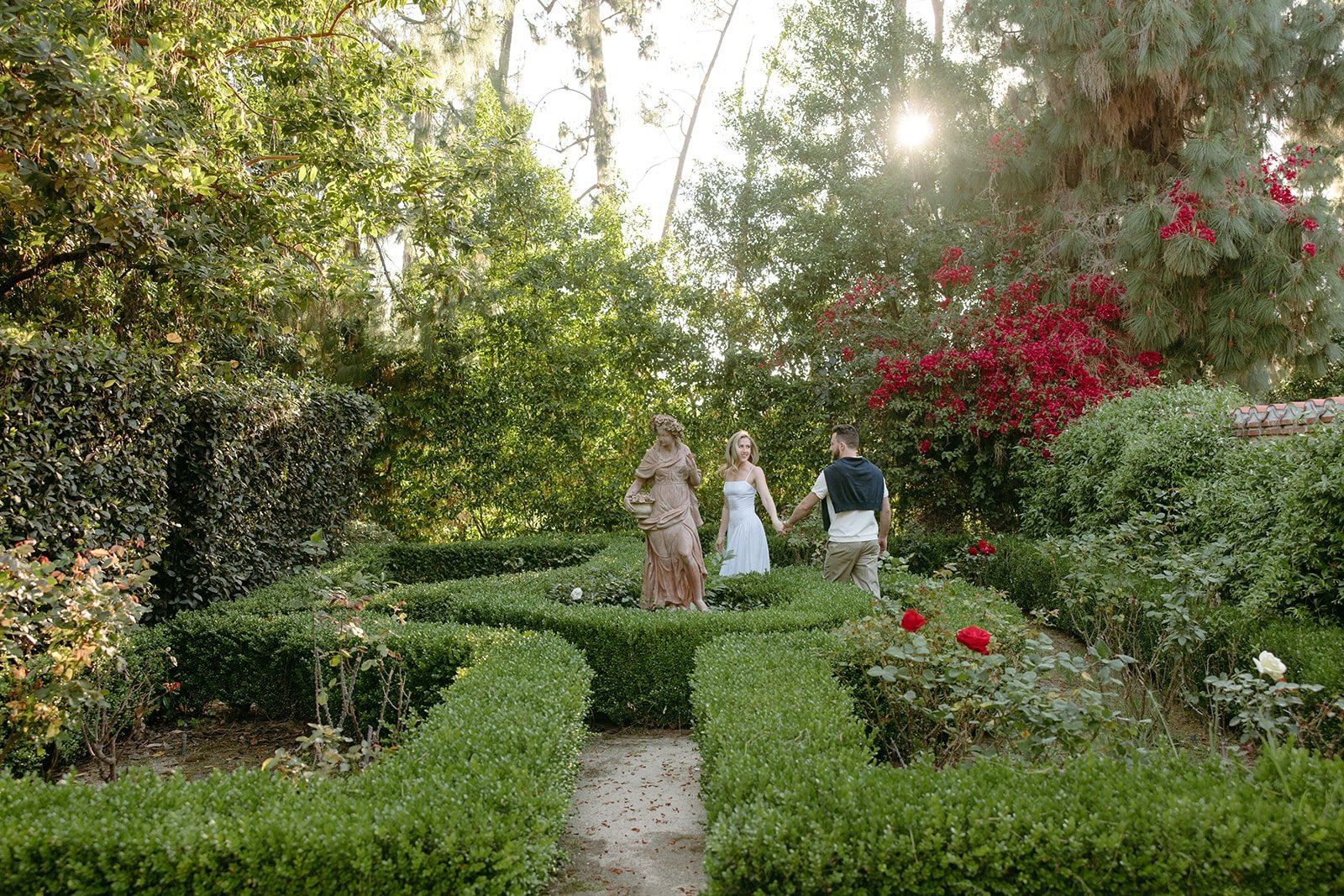rose garden maze at the etienne estate with couple and statue