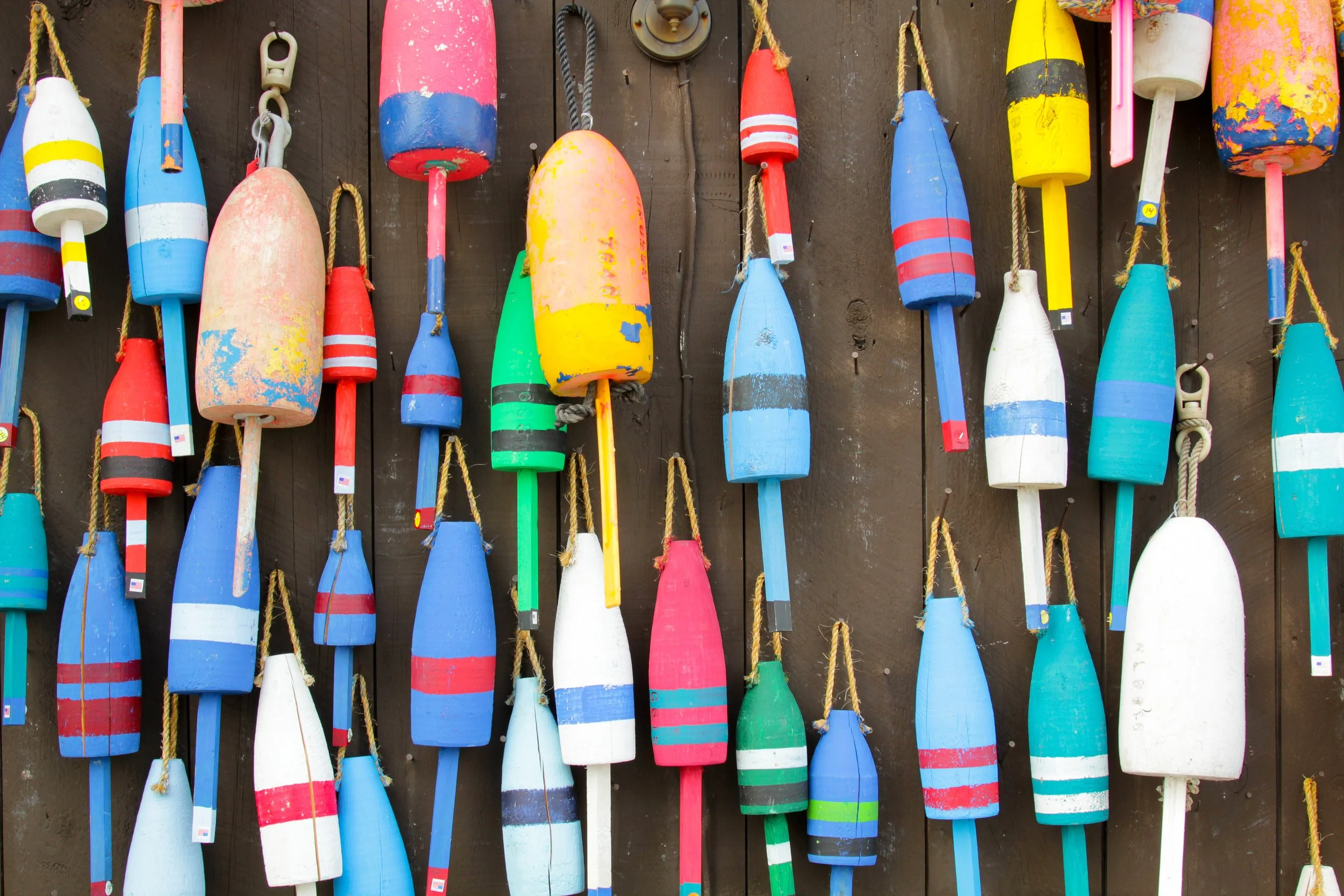 bigstock-Colorful-buoys-on-a-wall-of-a--76102190.jpg