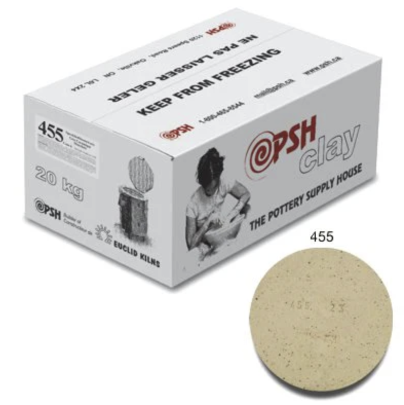 A white cardboard box labeled 'PSH Clay, The Pottery Supply House,' with a picture of a girl working with clay, and weight '20 kg.' Next to the box is a round, beige clay tile with the number '455' on it.