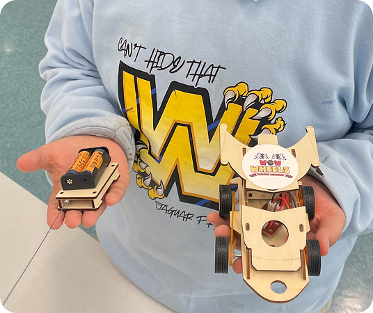 Kid holding WOW Wheelz Robotic Car